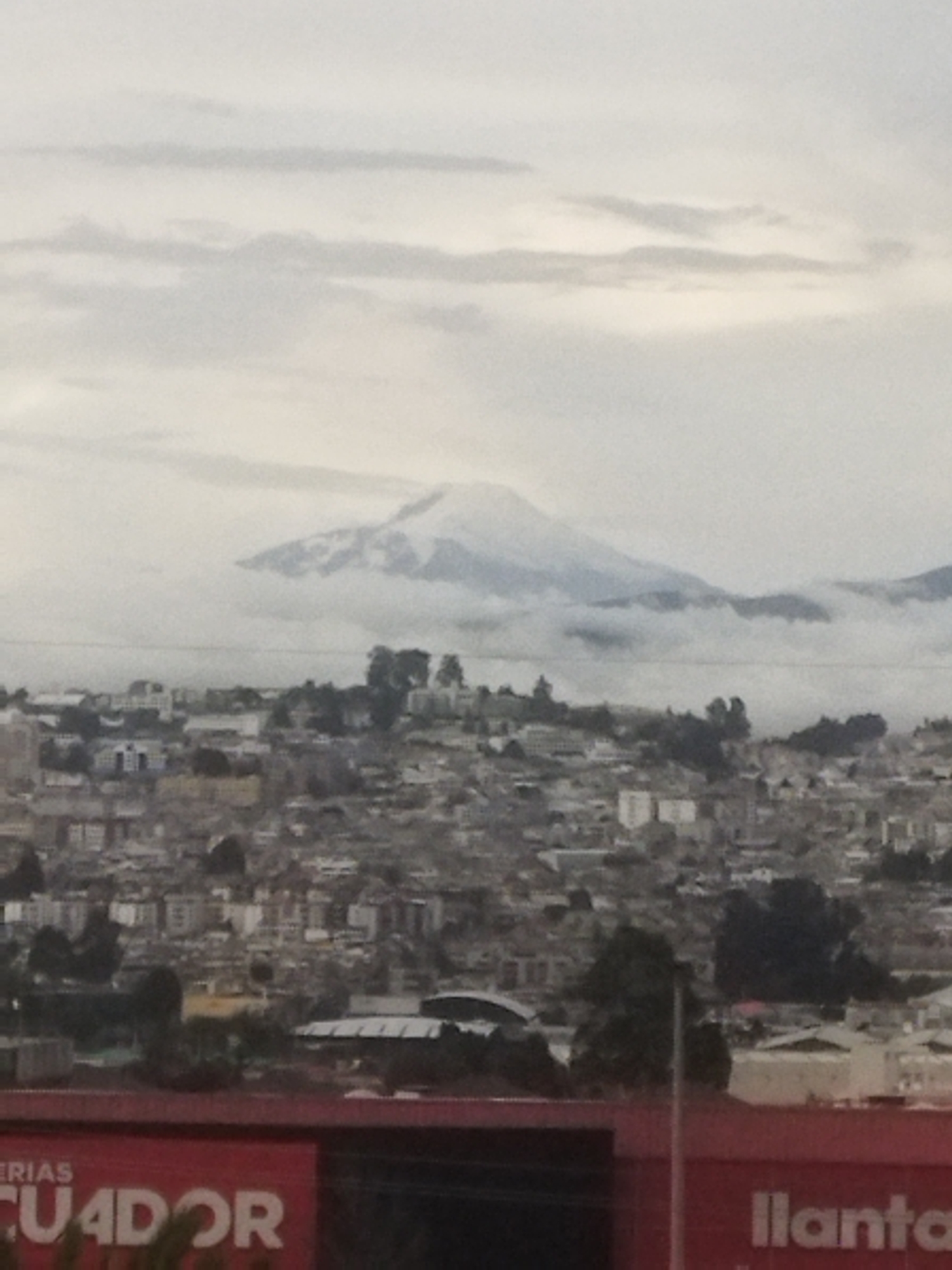 High-rise construction documented against mountain cityscape backdrop