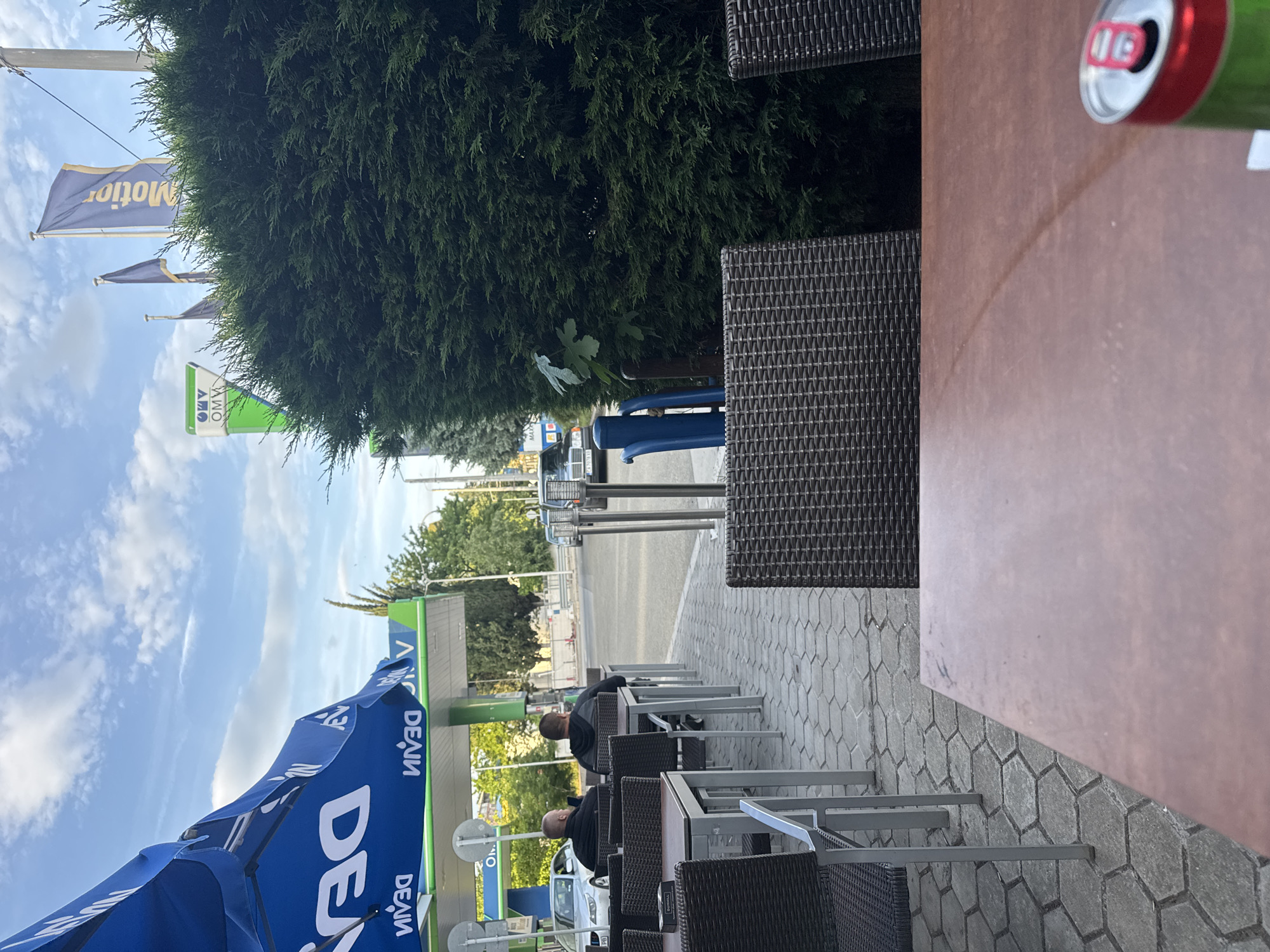 Man drinks energy drinks at Bulgaria gas station cafe