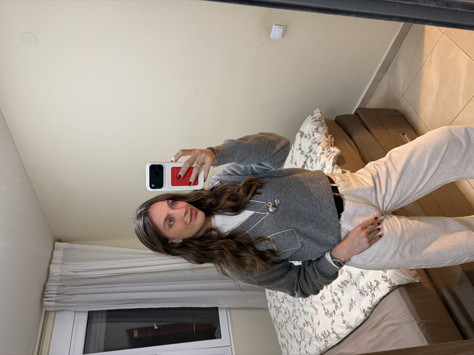Woman takes selfies, relaxes indoors in Budva with dog