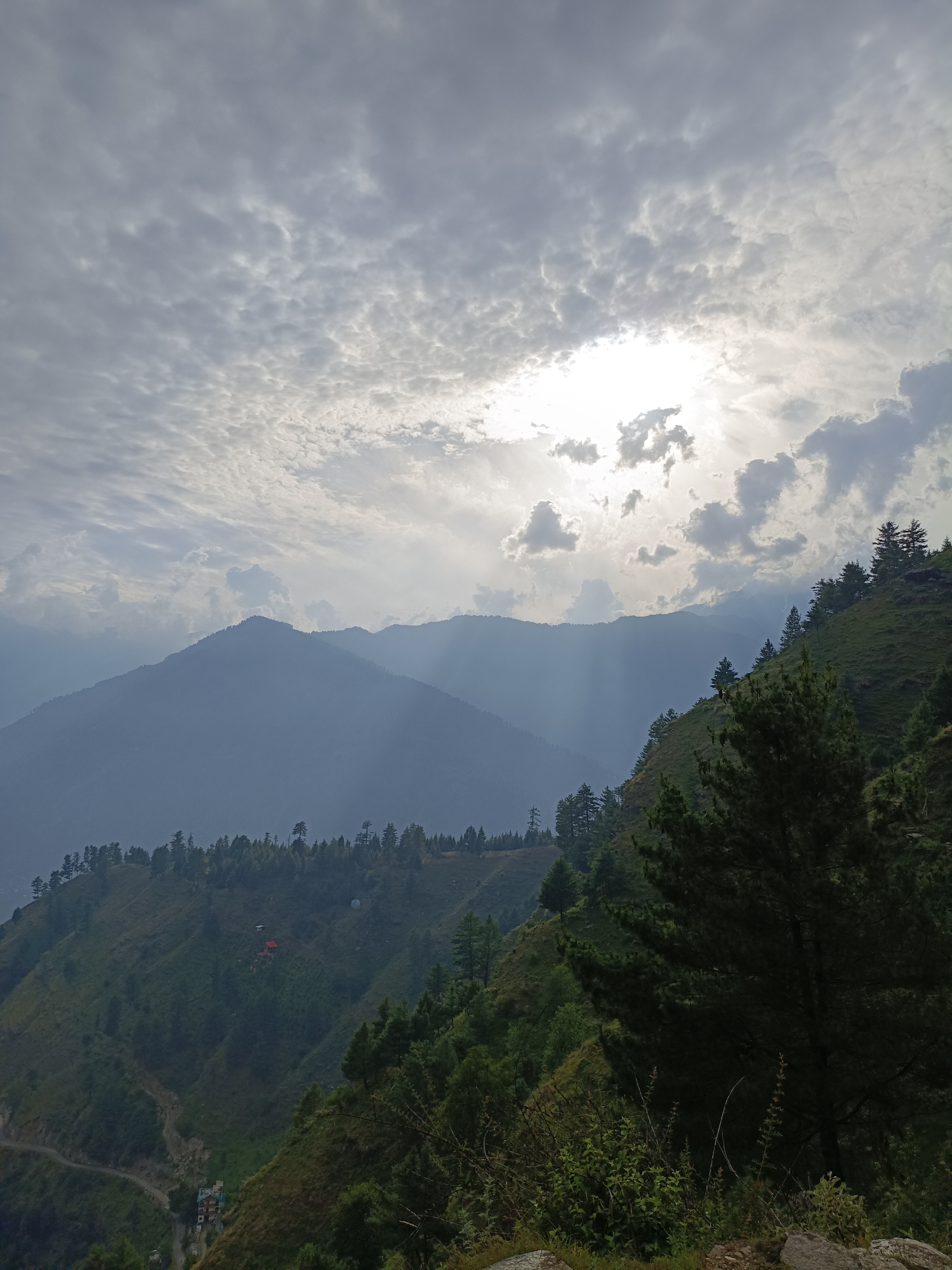 Misty mountain valley and dramatic skies in Damadi, India