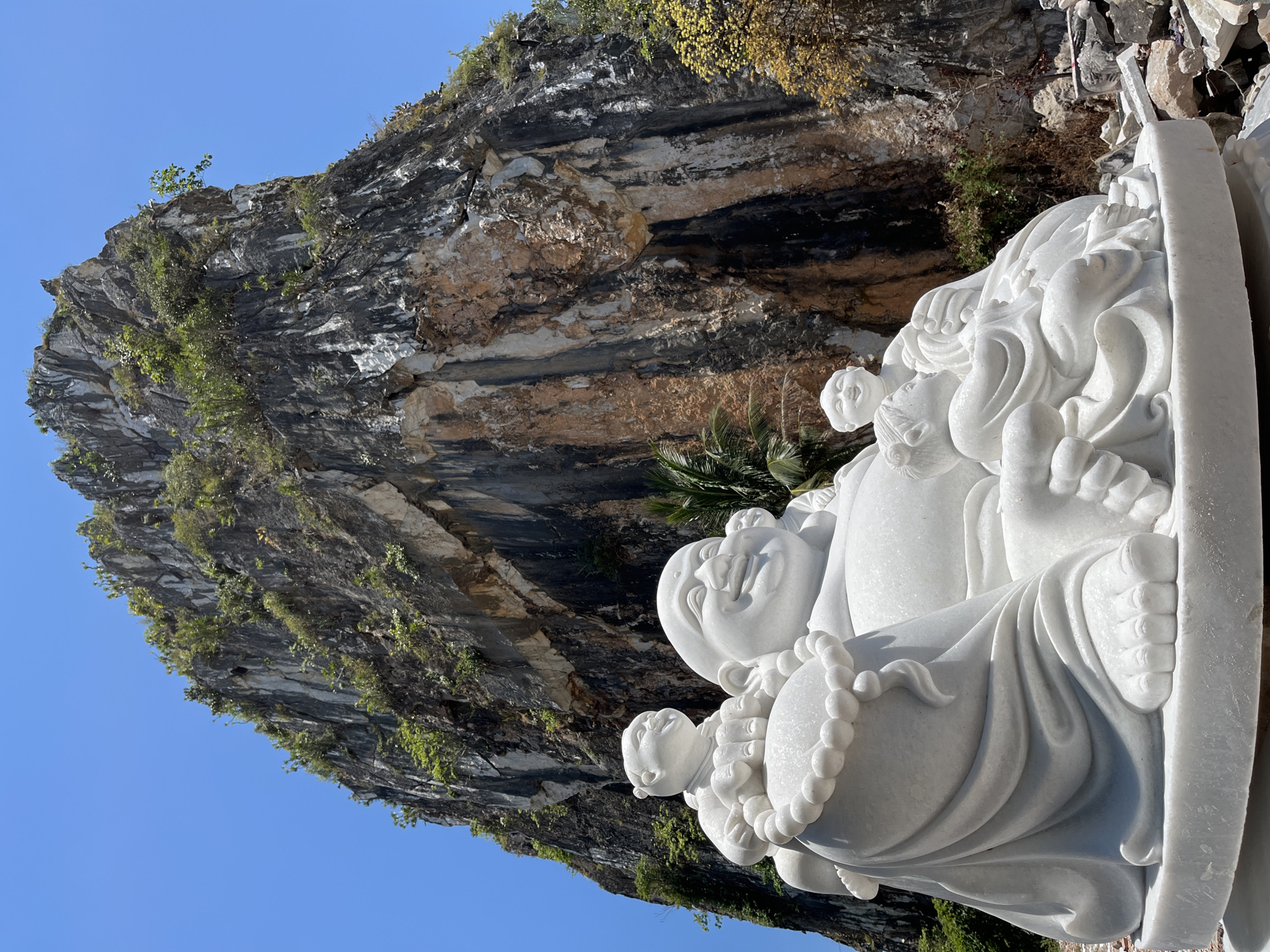 Tourist documents Buddhist statues at Đà Nẵng's Marble Mountains