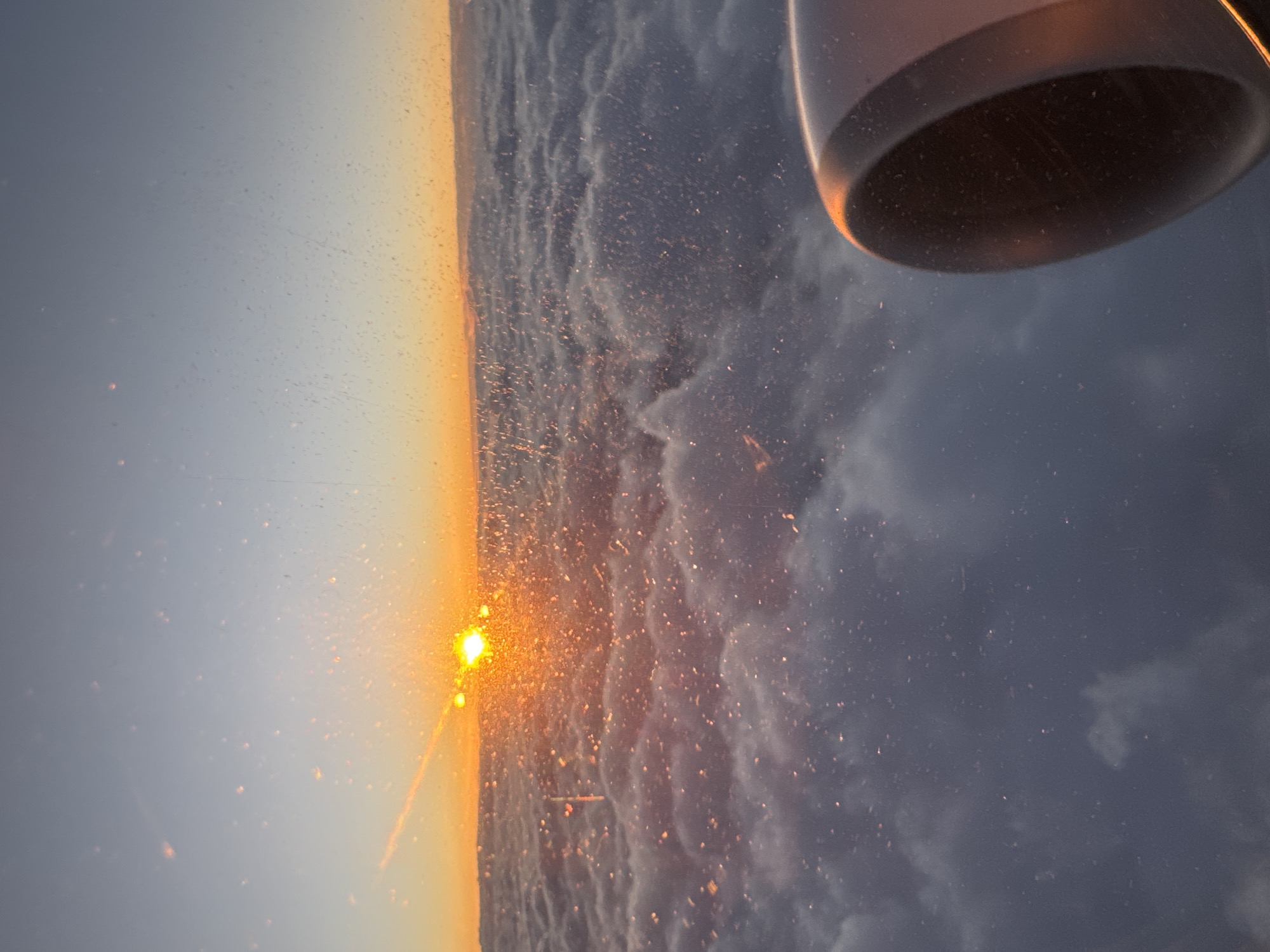 Passenger documents dramatic sunset from aircraft over Vecsés, Hungary