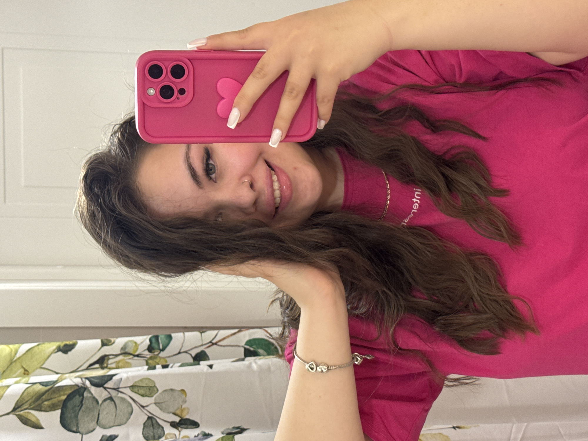 Woman takes mirror selfies with pink phone in Russia