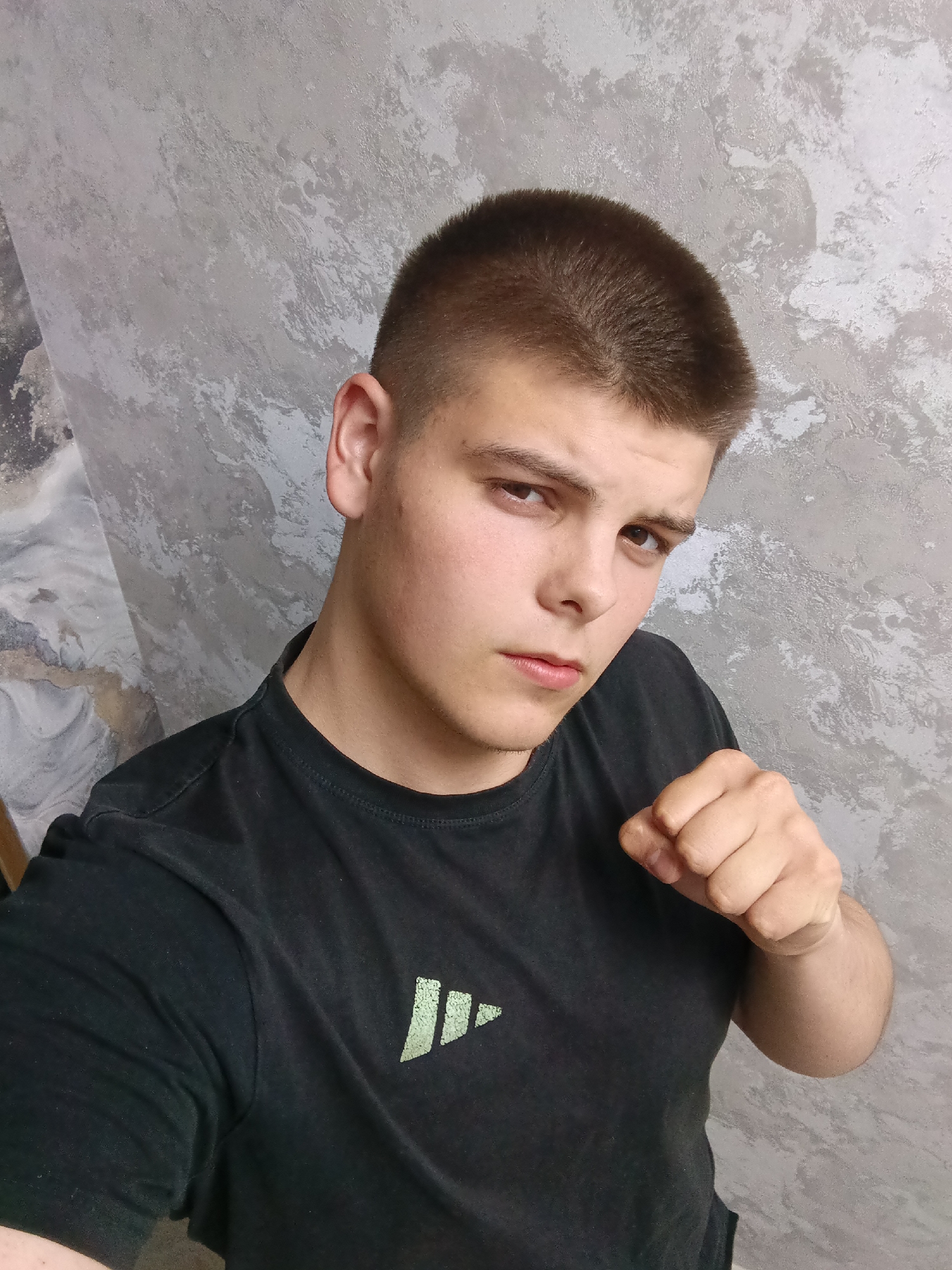 Young man poses with objects during indoor photo session