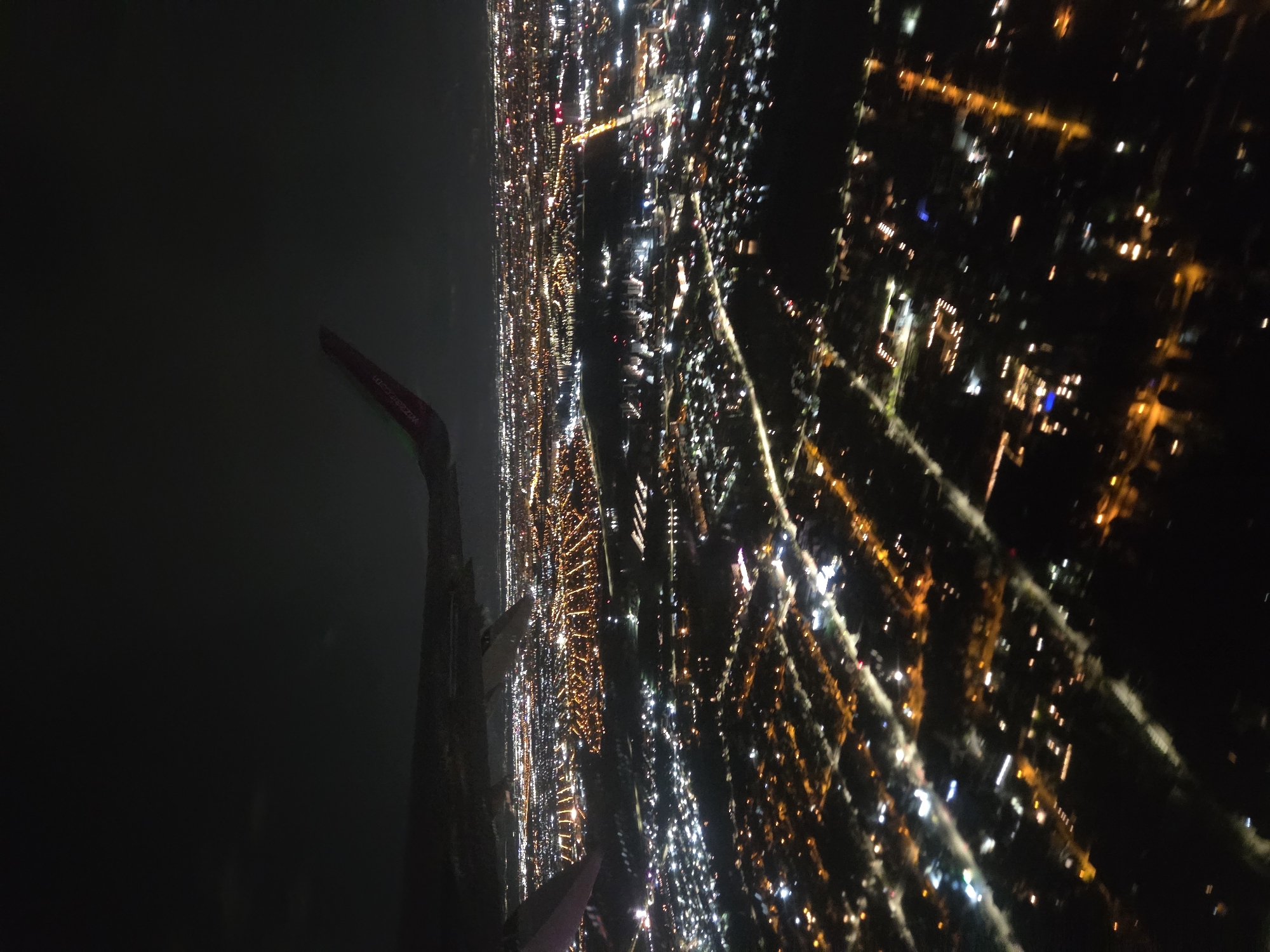 Nighttime aerial view captures illuminated Voluntari cityscape