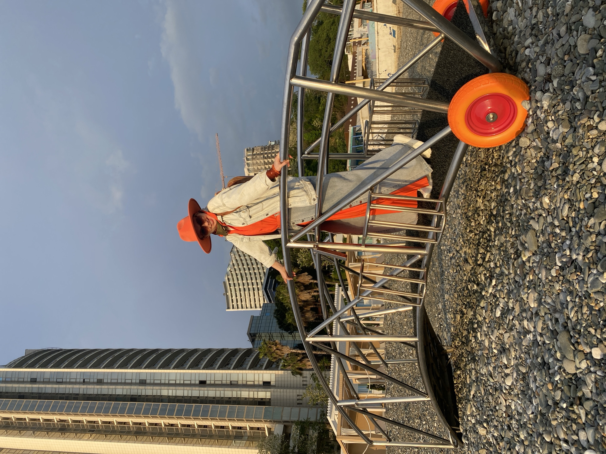 Tourist in orange outfit explores Sochi beachfront attractions