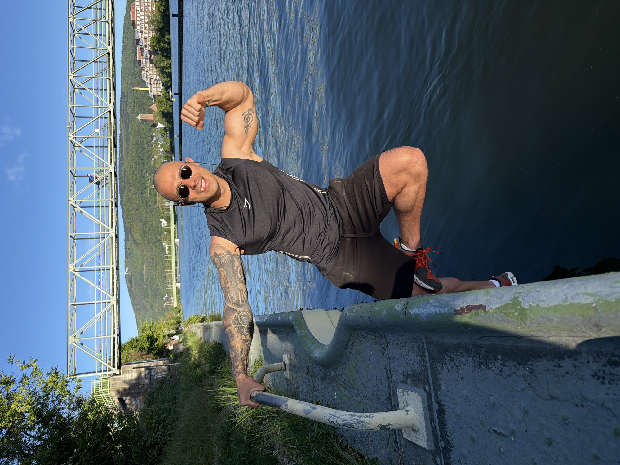 Man poses for riverside photo in Heidelberg