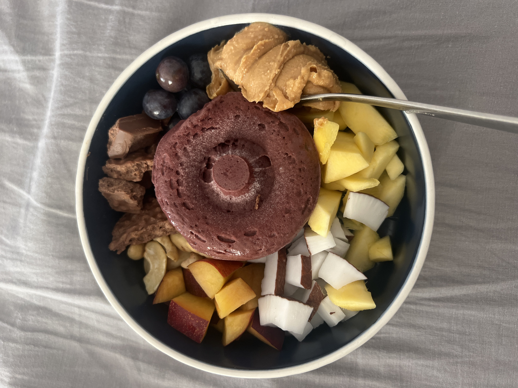 Home cook prepares tropical bowl with fresh coconut