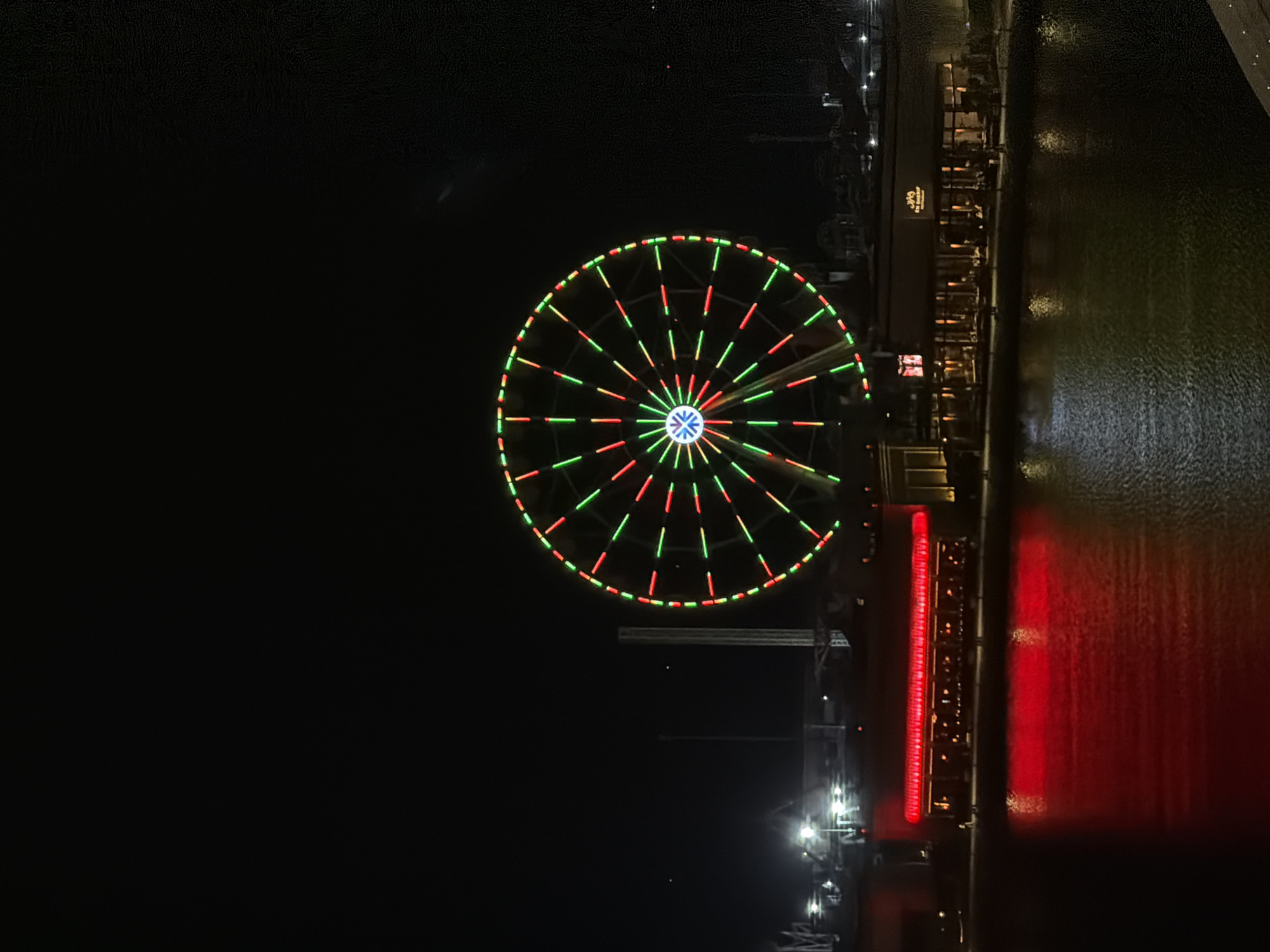 Evening drive through a lit-up Middle Eastern city waterfront