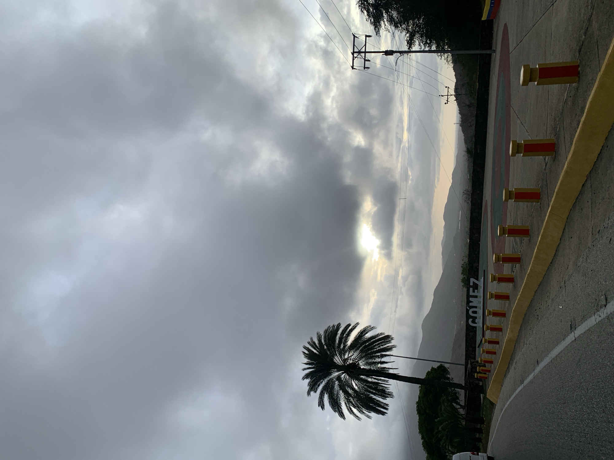 Evening traffic flows through La Asuncion under cloudy skies