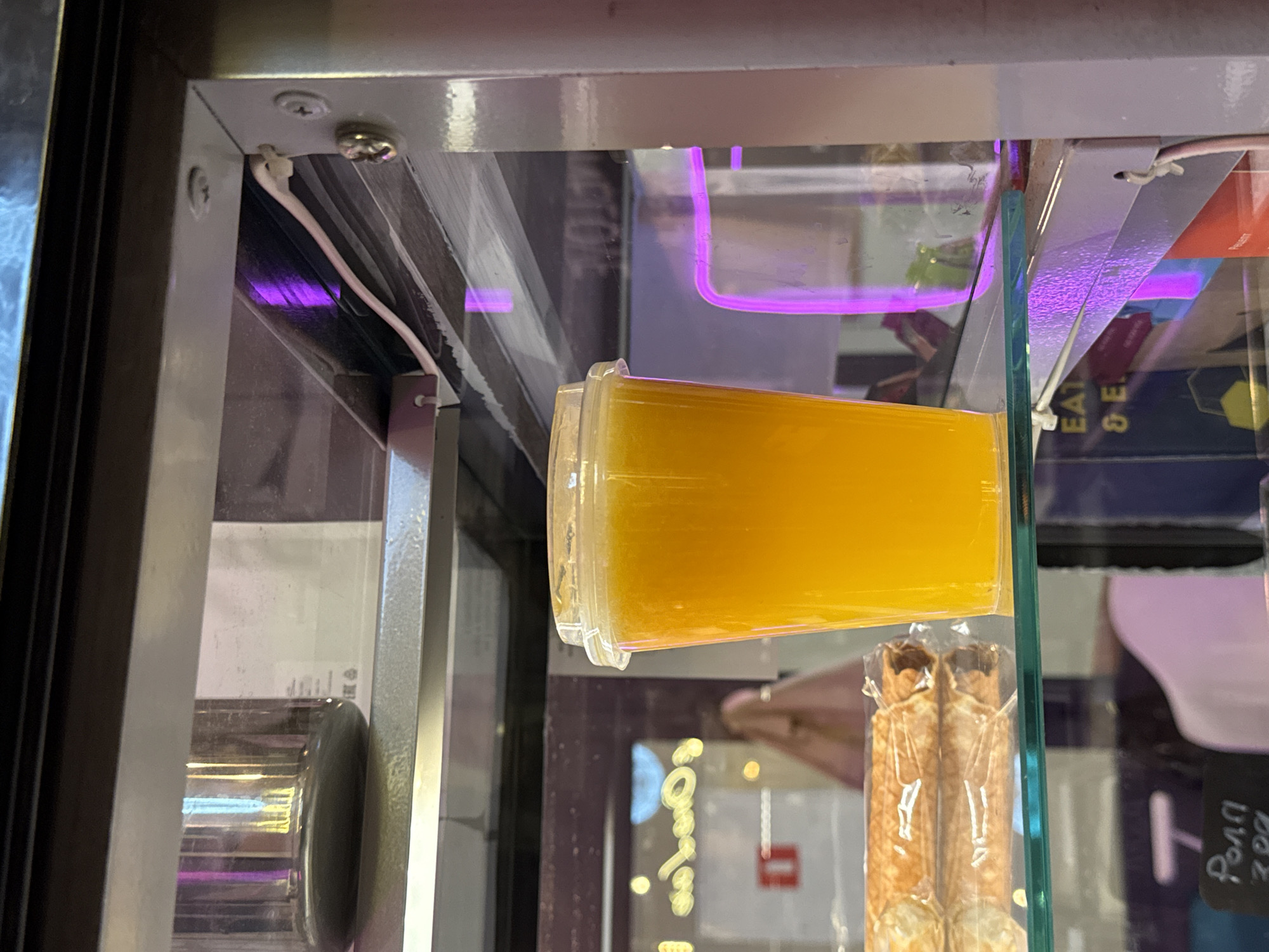 Orange drink and a snack on a glass shelf in Moscow