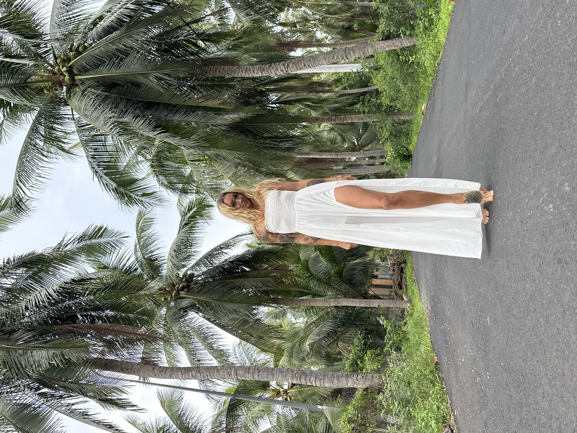 Two Women Hold Photo Session on Palm-Lined Road
