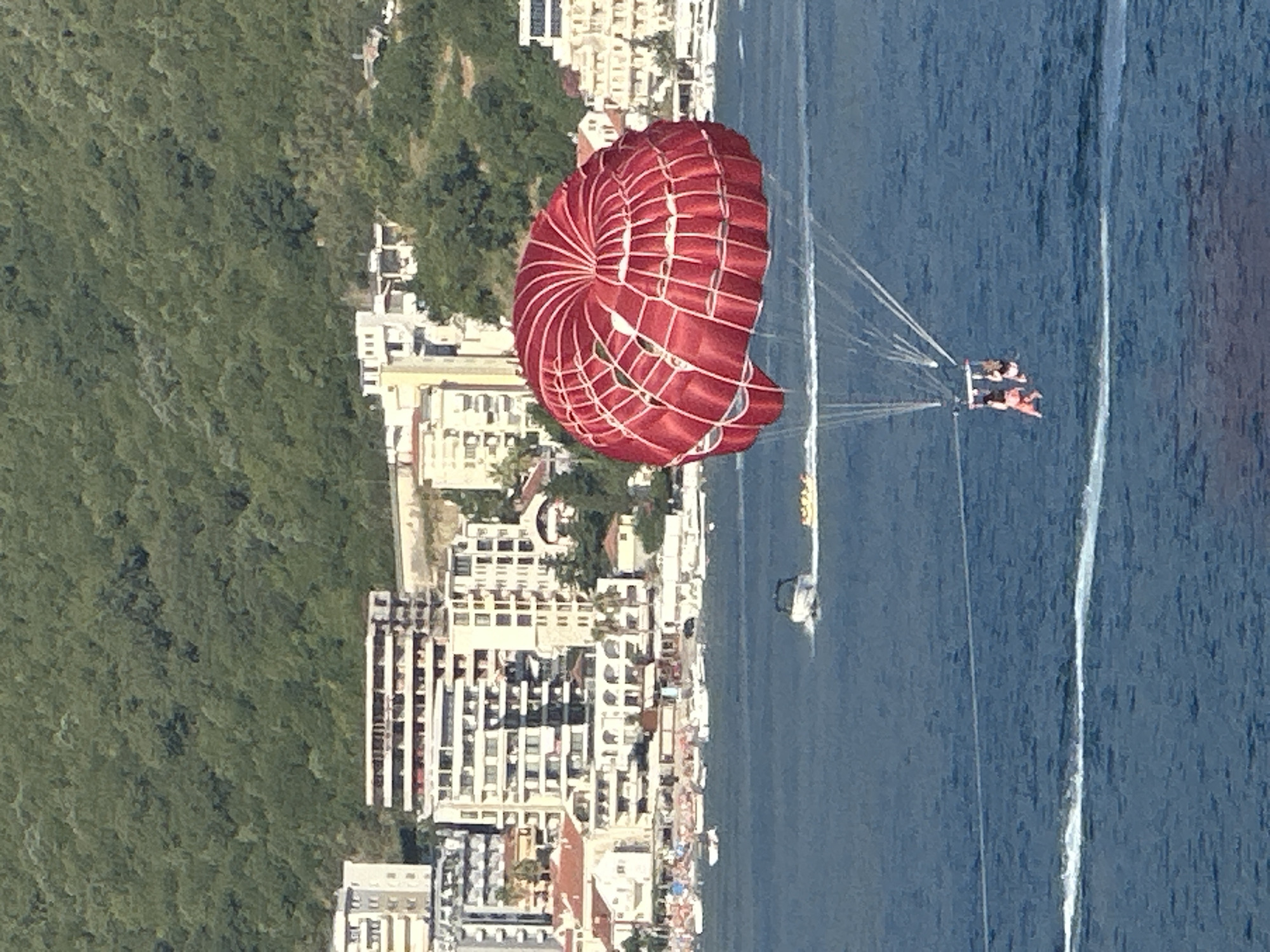 Red parasail rides the wind over Budva's Adriatic waters