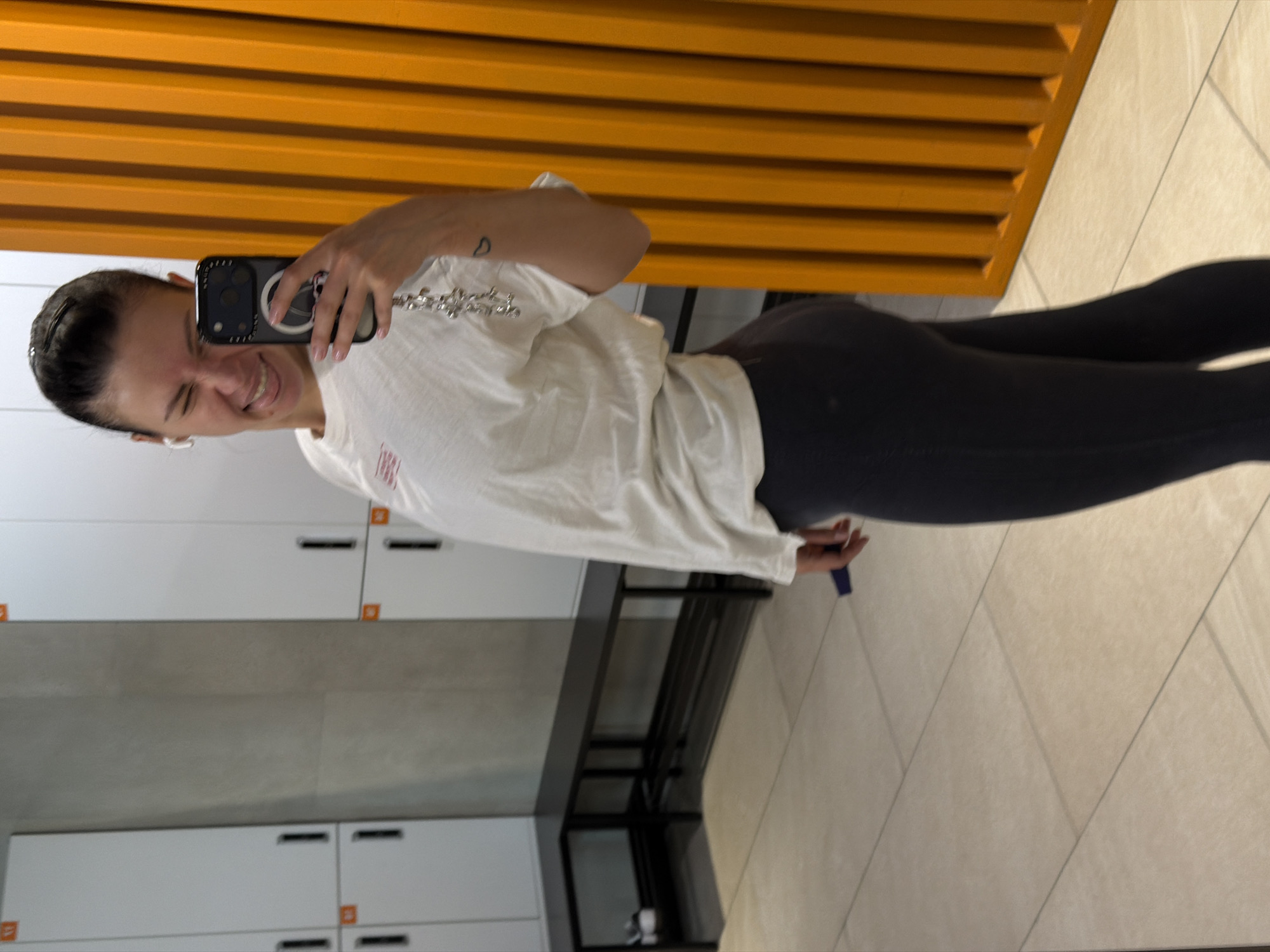 Woman takes mirror selfie in Moscow gym locker room