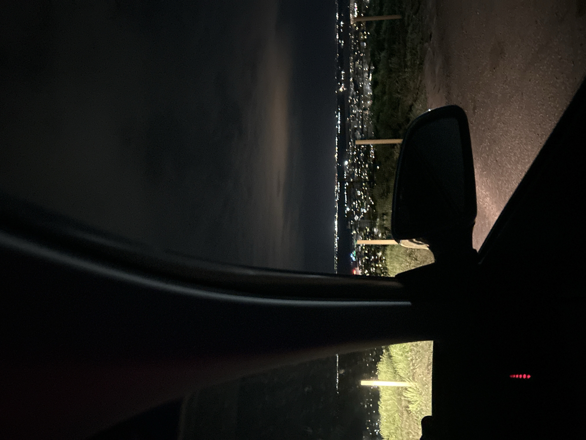 Motorist pauses roadside in Silistra, observes distant city lights