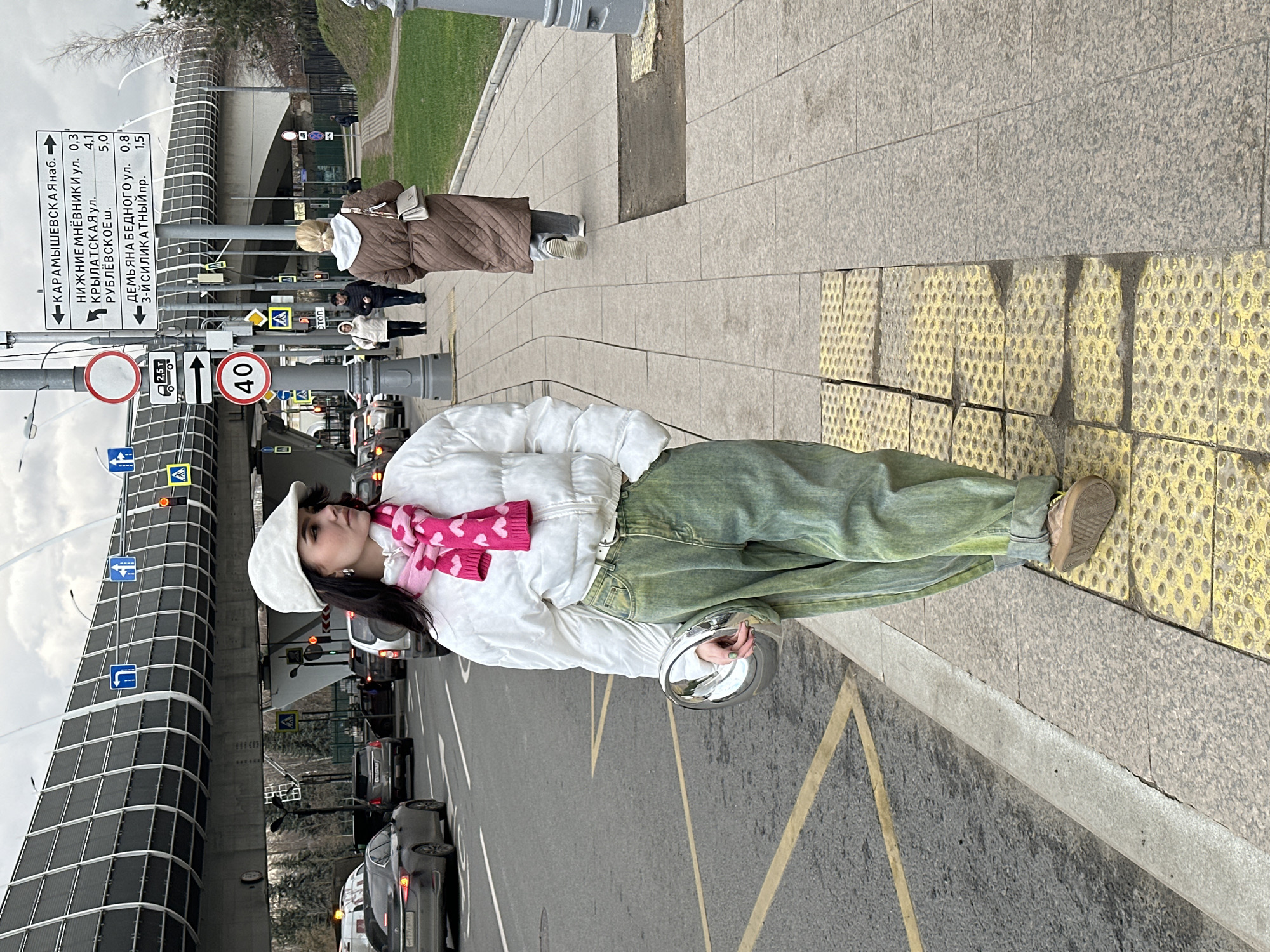 Woman in colorful outfit spotted near parked vehicles in Moscow