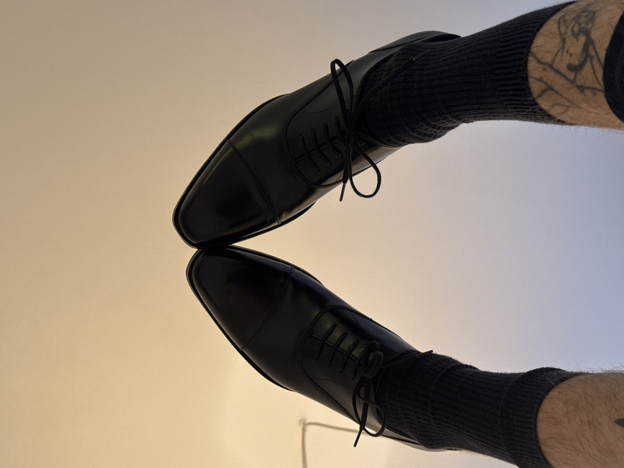 Black Oxford shoes photographed from above in Paris