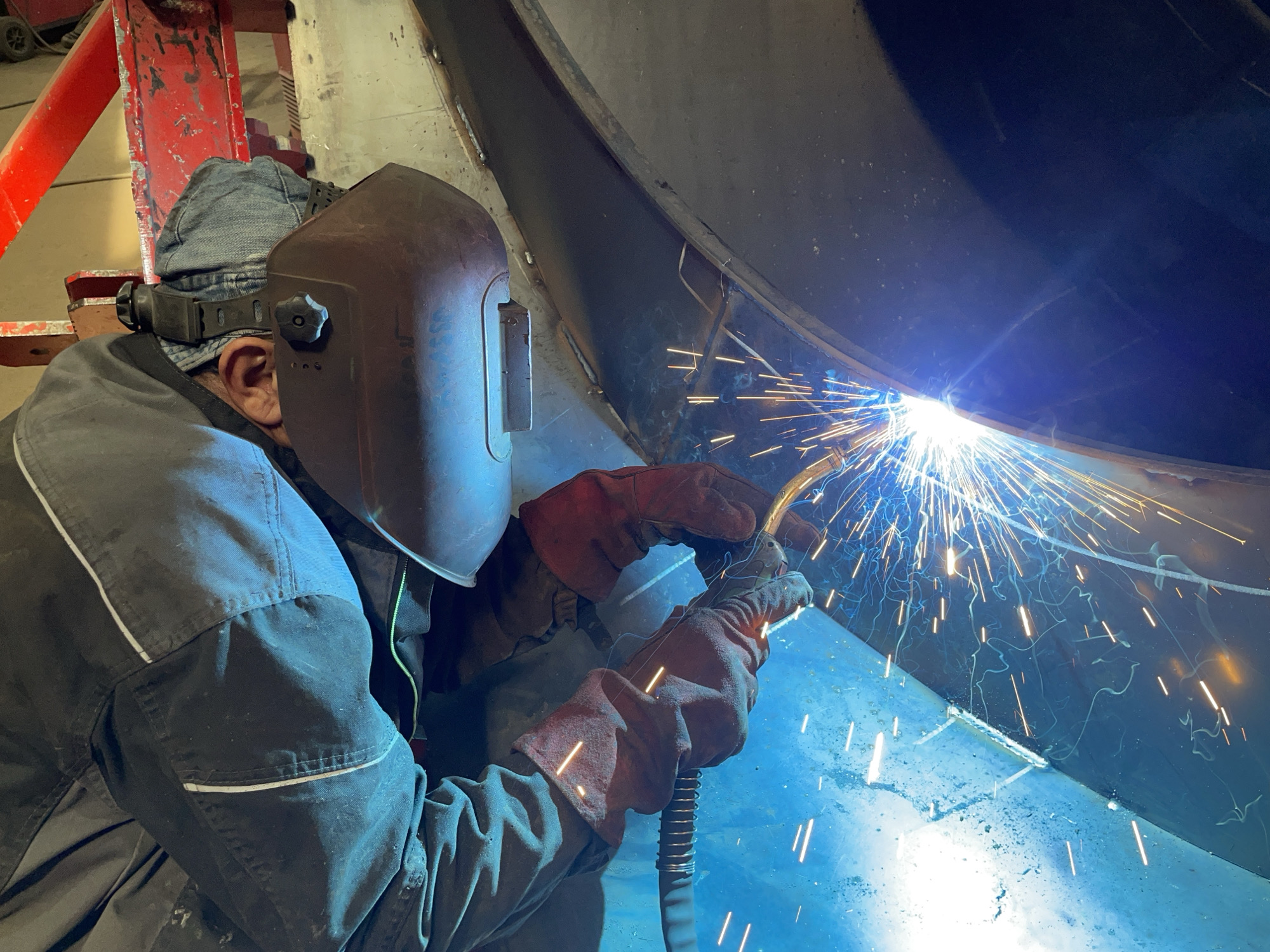 Welder works on metal structure in Tomba, Montenegro