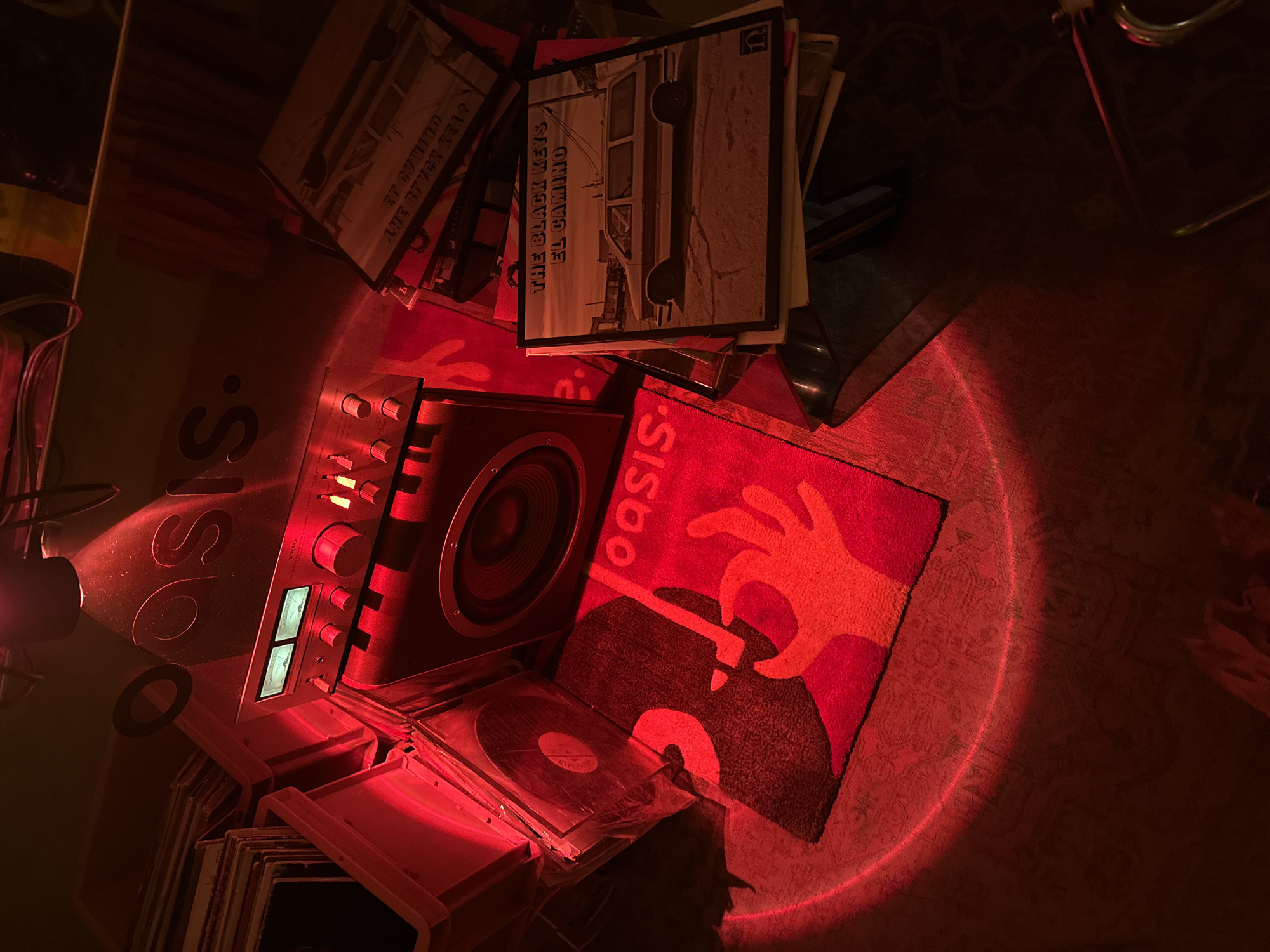 Vinyl collection documented under red lighting includes Black Keys album