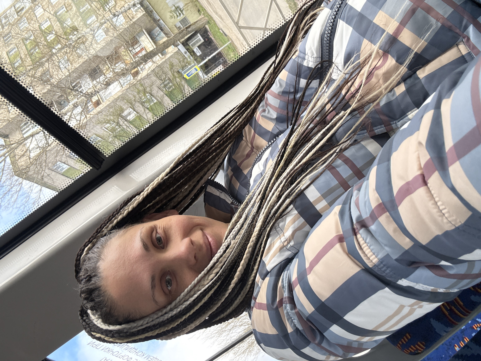 Woman with braids rides public transport in Rusanovo