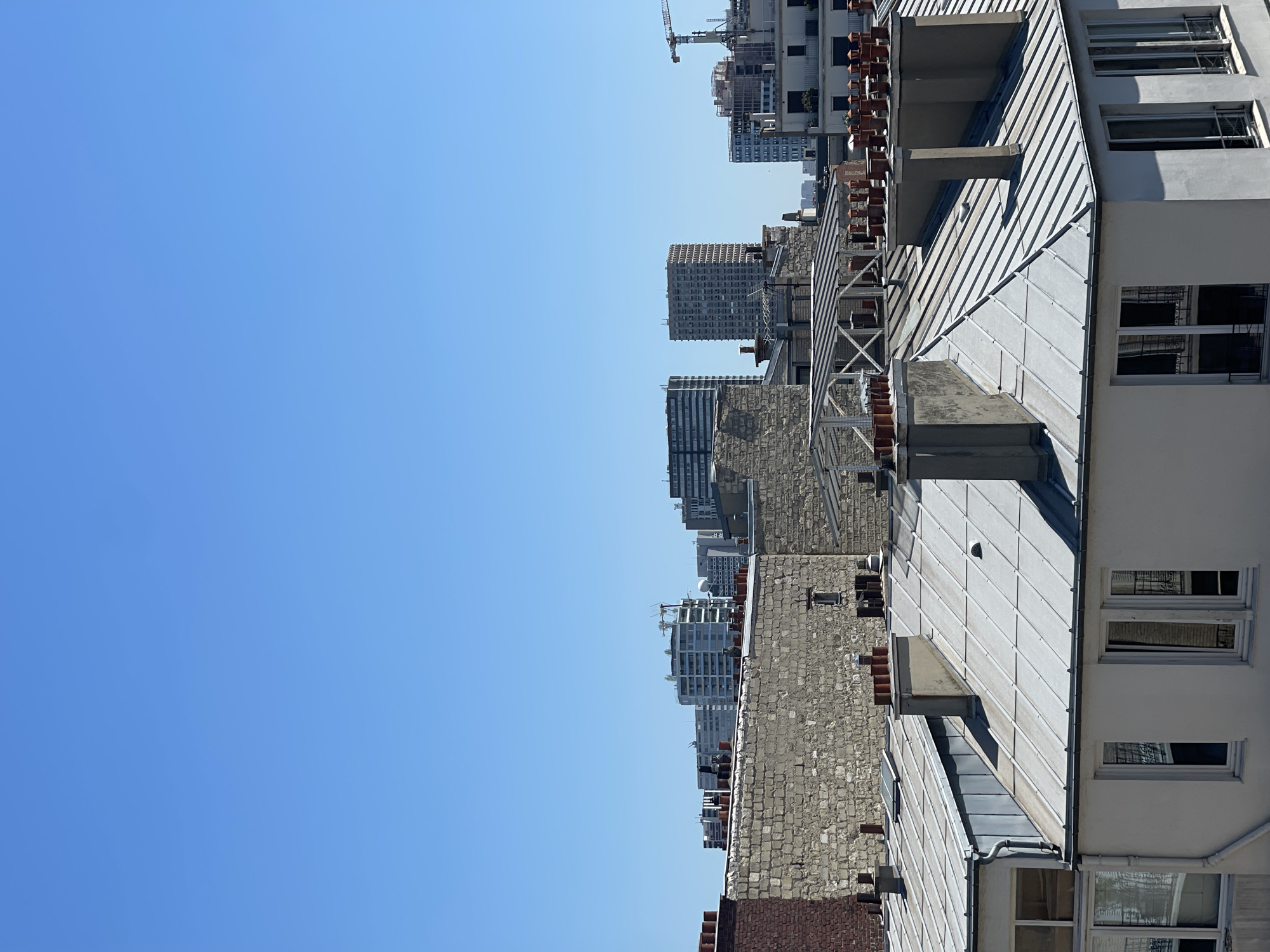 Paris rooftops under a clear blue sky