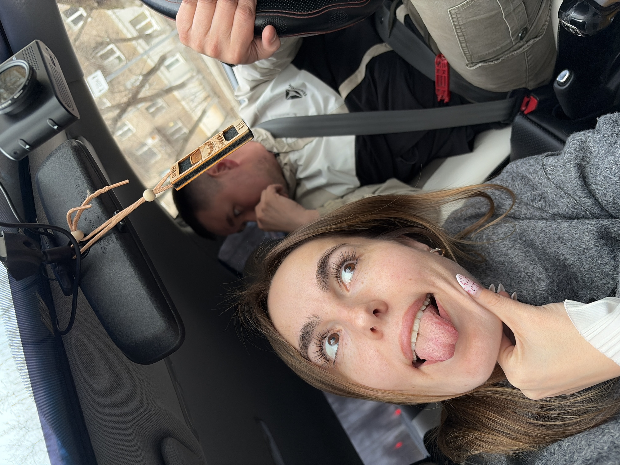 Two people photographed in car during Izhevsk city drive