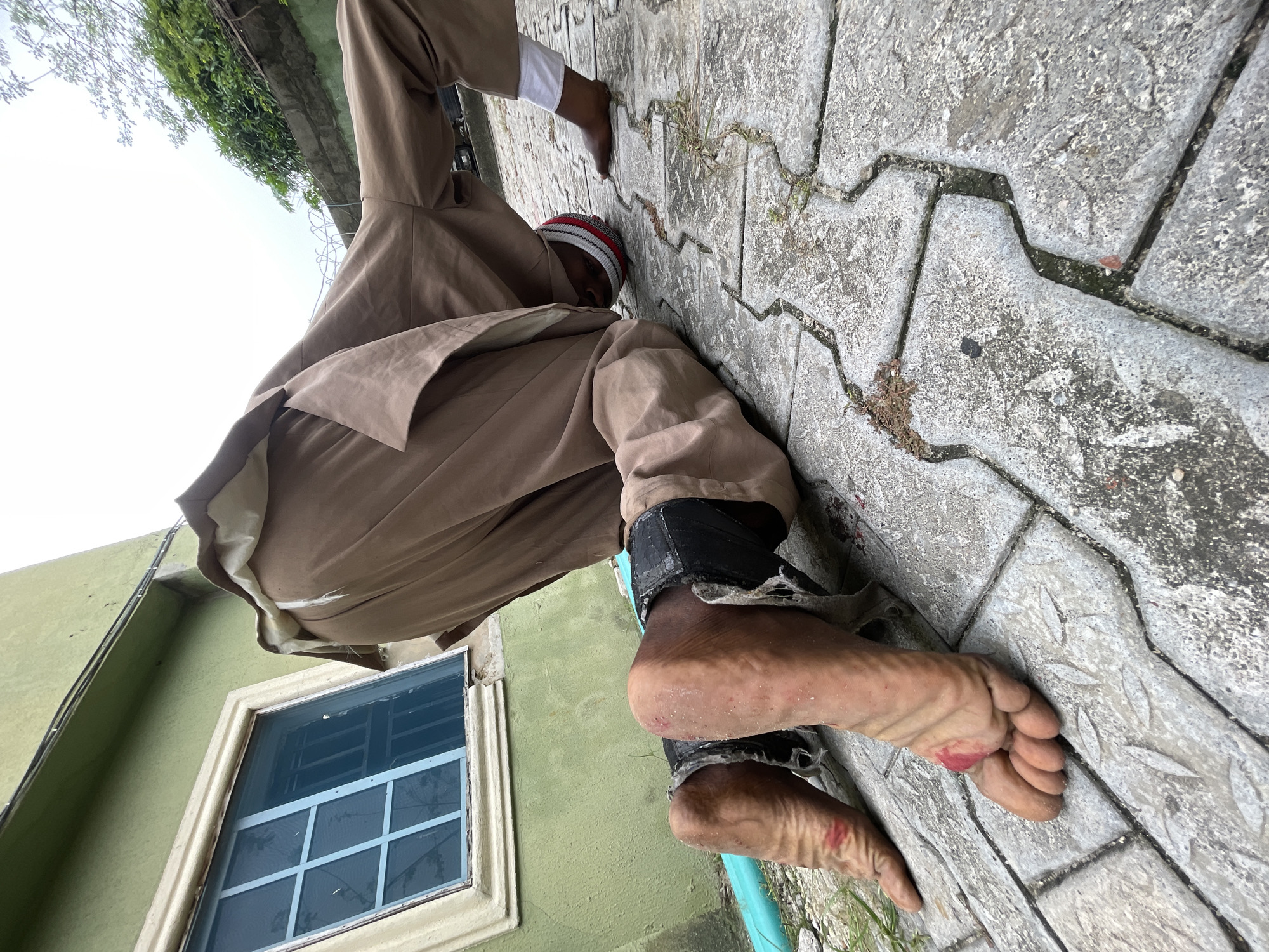 Man in striped hat documented across Ado, Nigeria