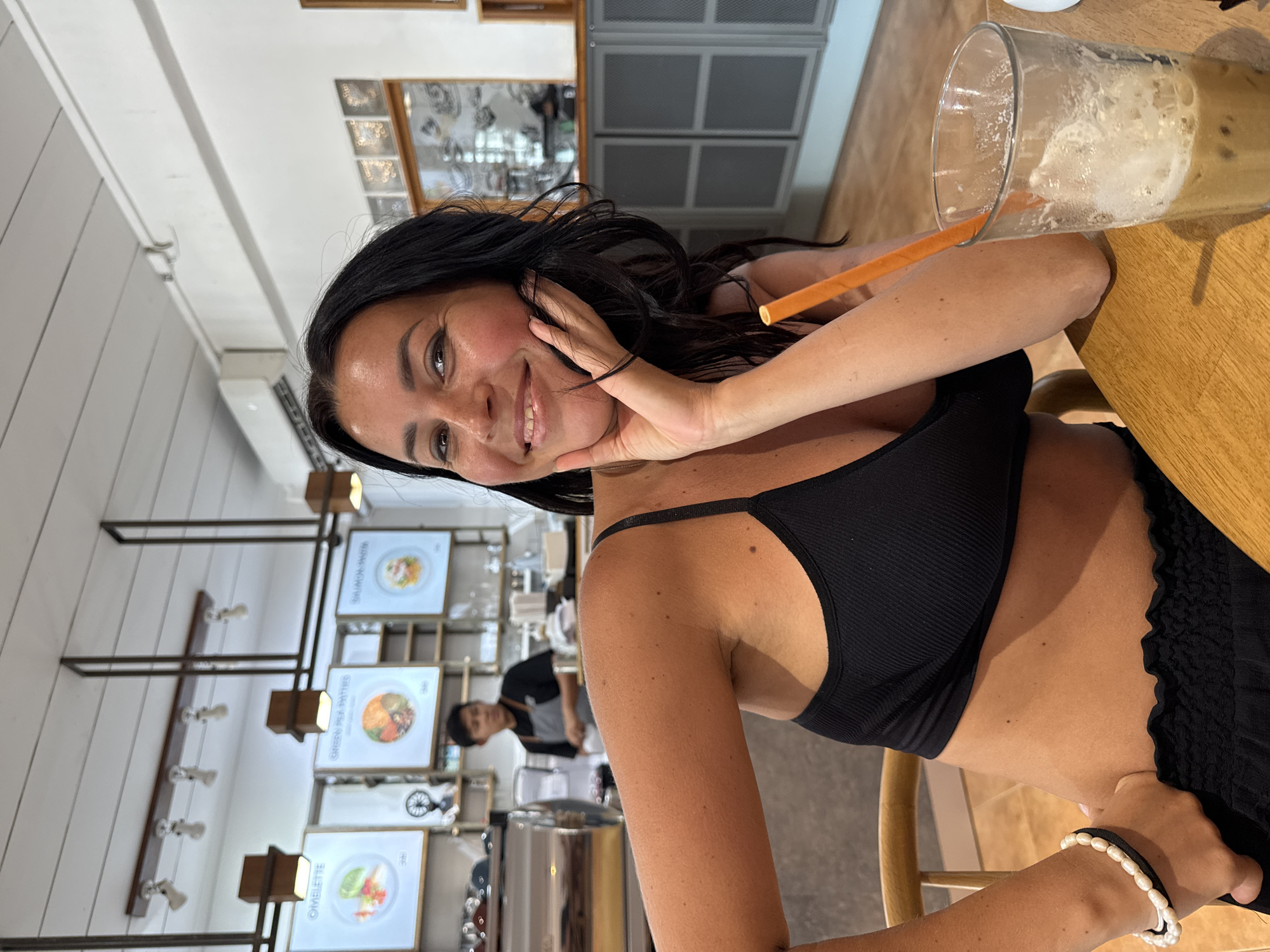 Woman photographed smiling at cafe table in Thong Sala