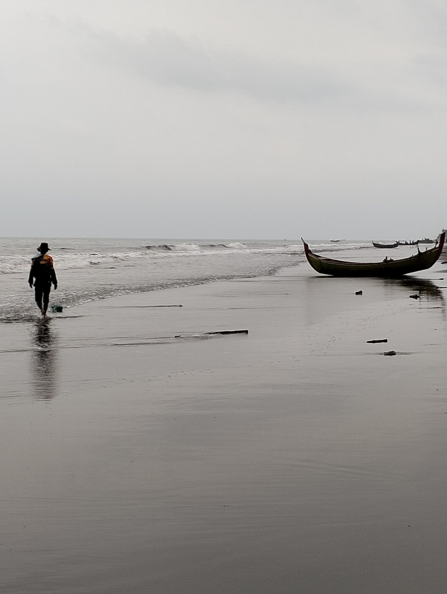 Quiet beach scenes at dusk with fishing boats, Aceh coast