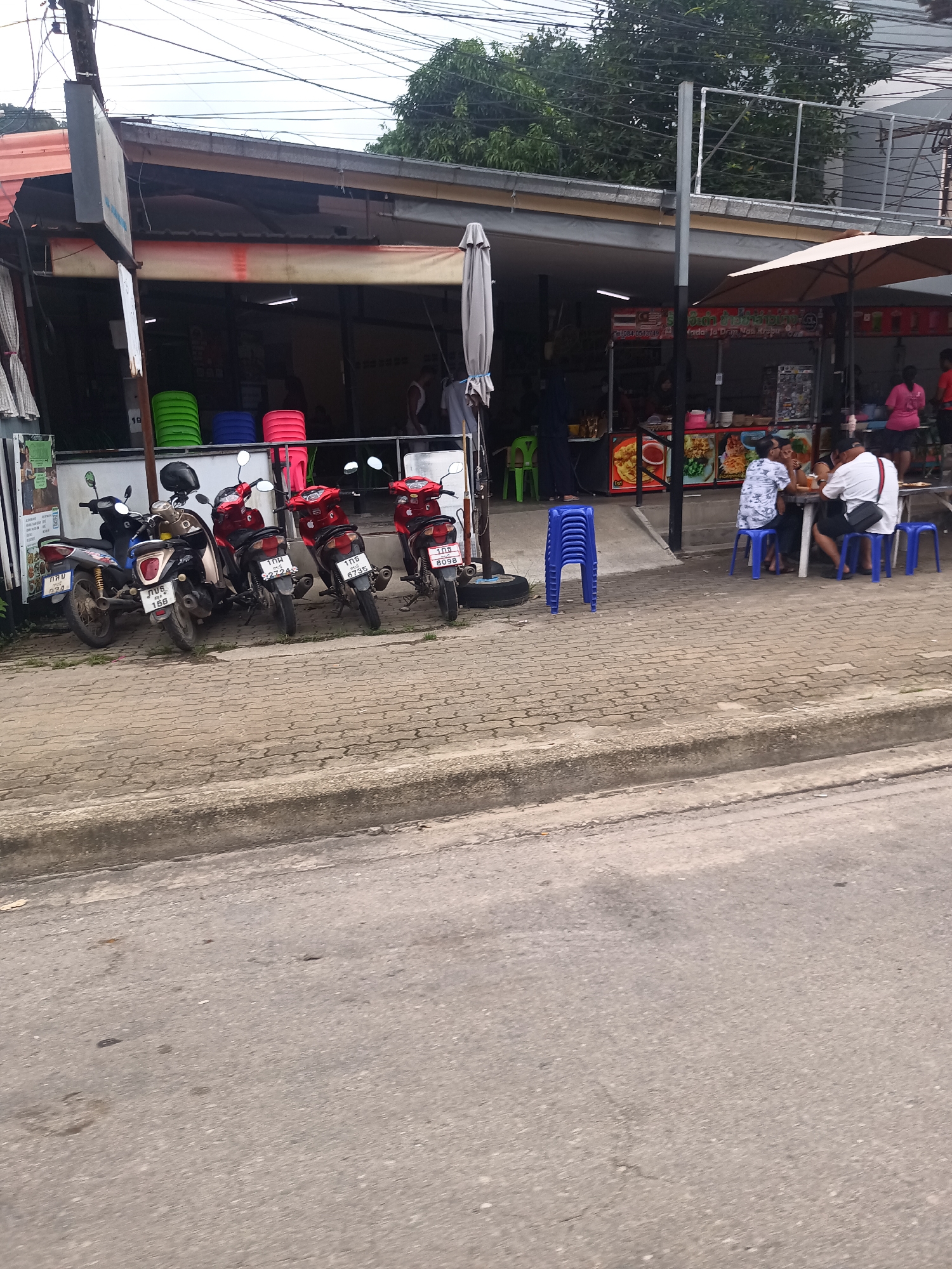 Motorbikes parked at roadside eatery in Ban Ao Nang