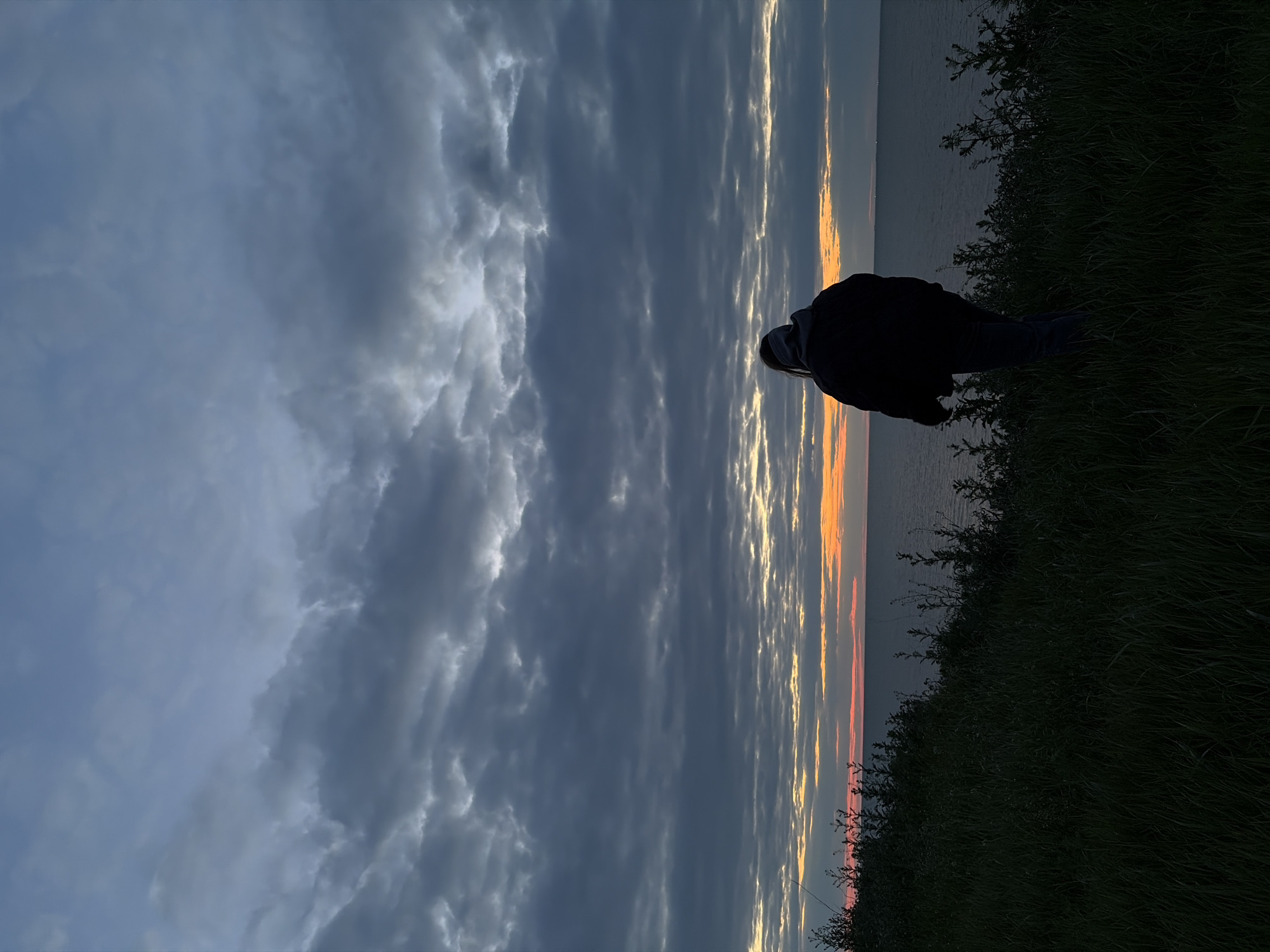 Figure silhouetted against dramatic sky in Port-Katon, Russia