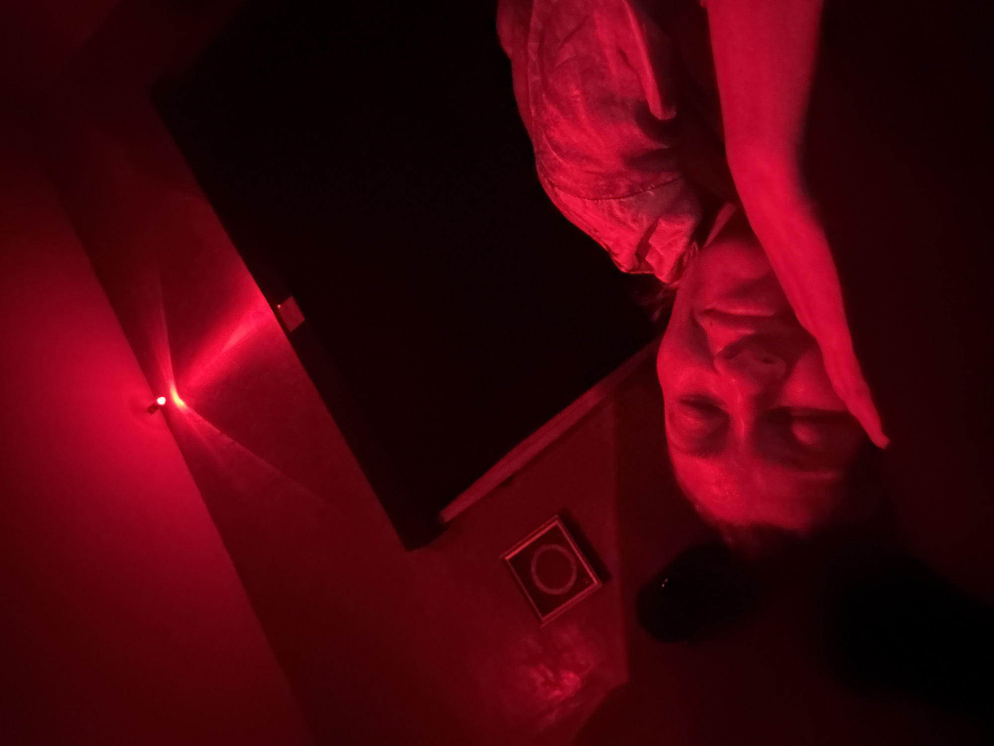 Red-lit indoor scene captured in Mengwi, Indonesia