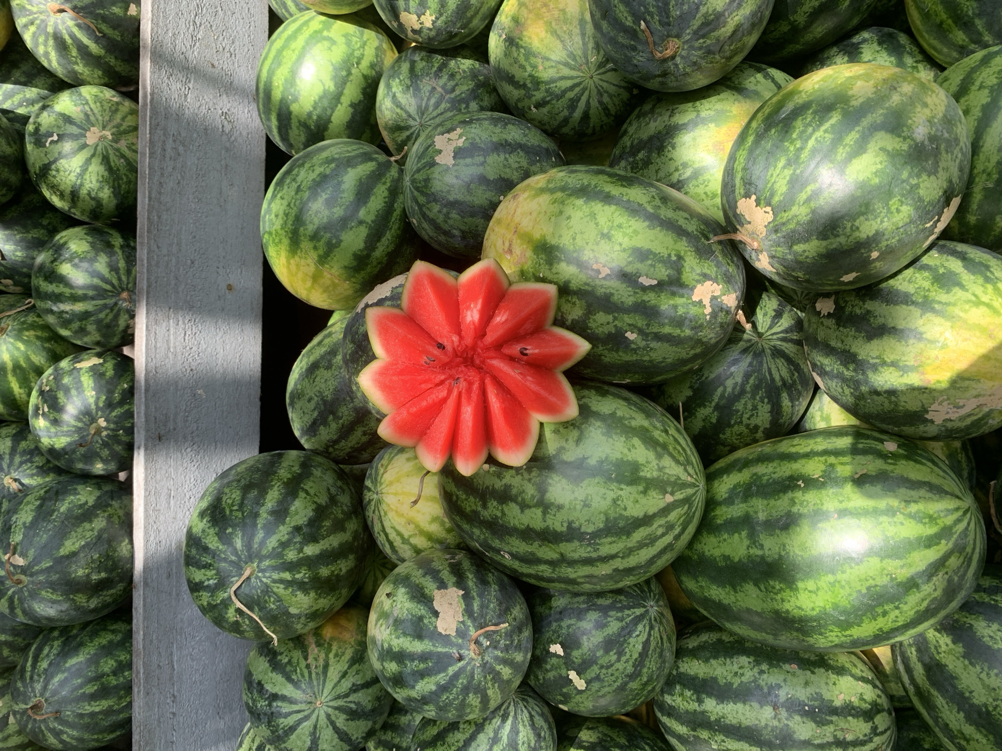 Watermelons and fresh coconuts at a Batawala market stall