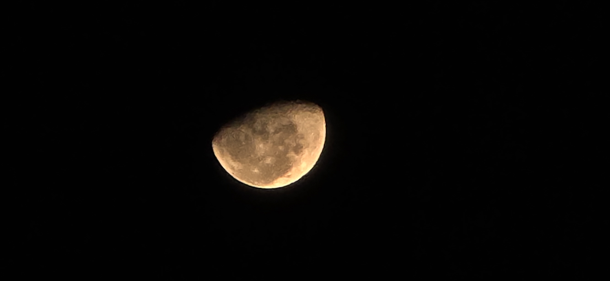 Volgograd night: illuminated monument and an orange moon