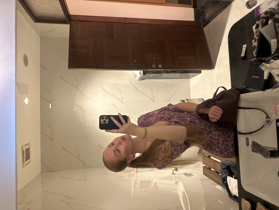 Woman takes mirror selfie in Betalbatim bathroom