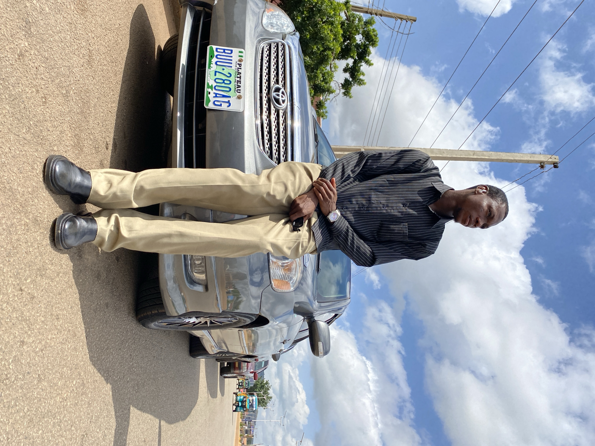 Sunny day street scene with a silver Toyota Corolla in Bukuru