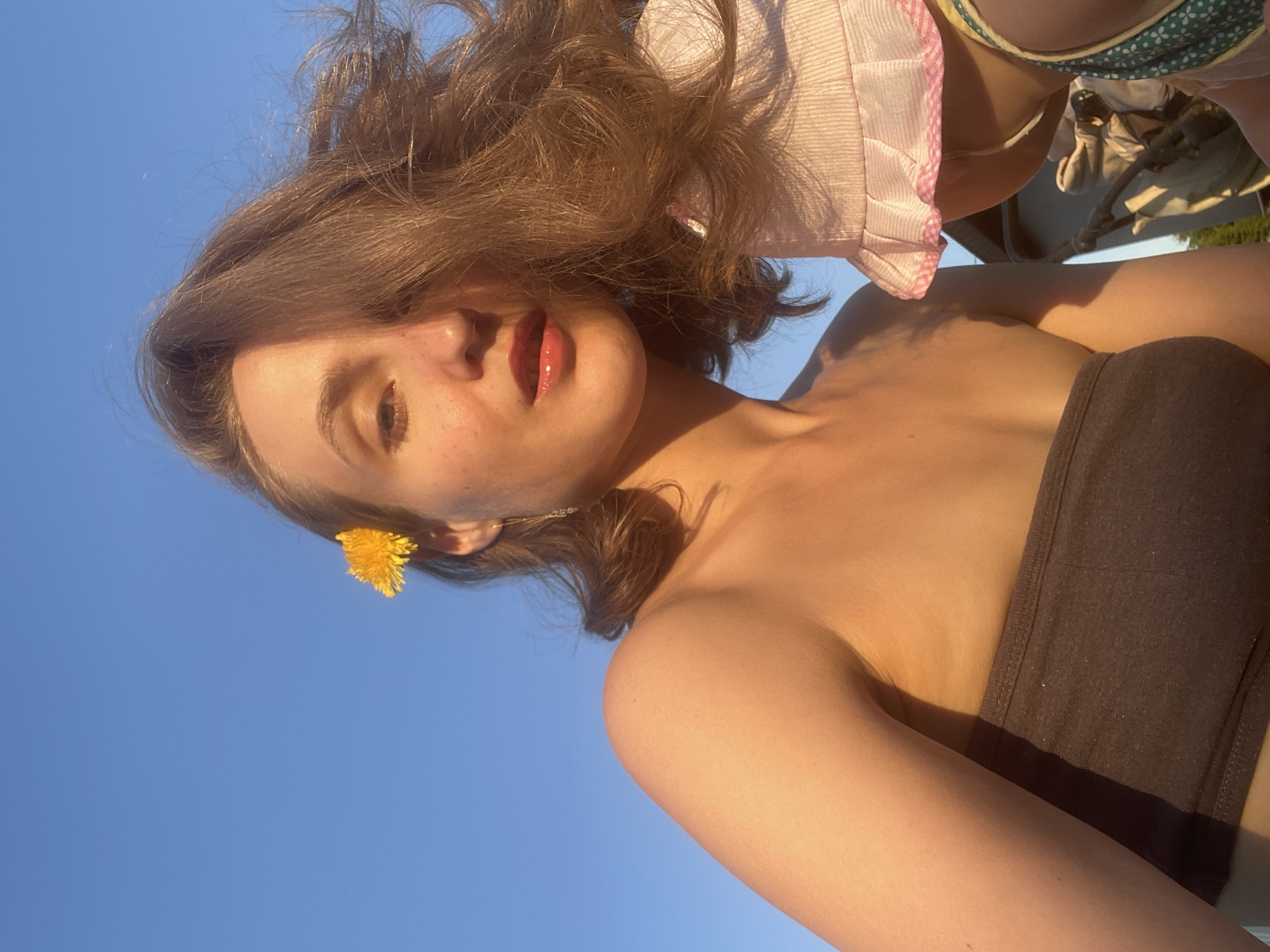 Woman poses with dandelions in outdoor photo session, Russia