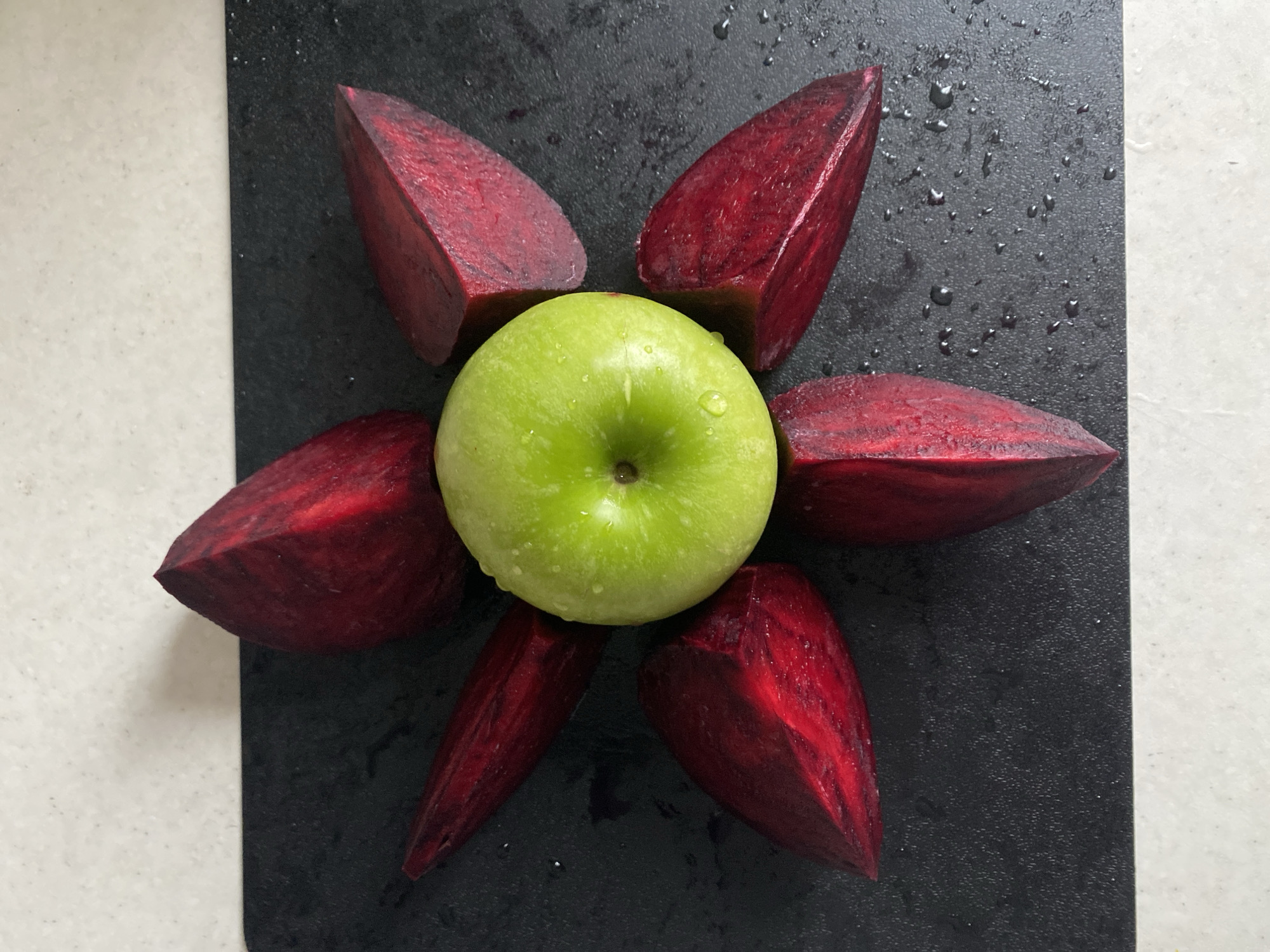 Apple and beet wedges arranged on cutting board in Sochi
