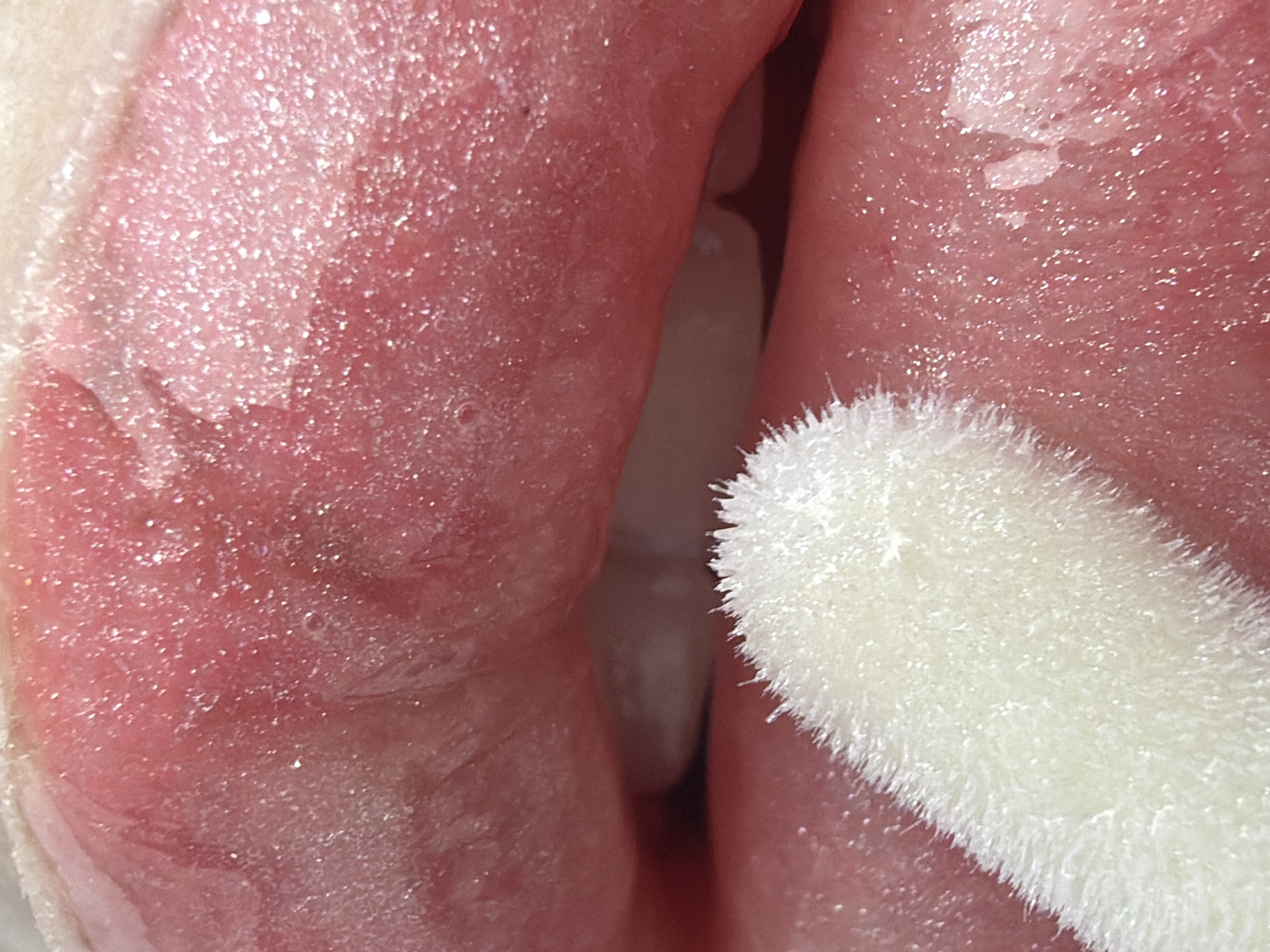 Person documents detailed skincare routine with lip gloss and masks