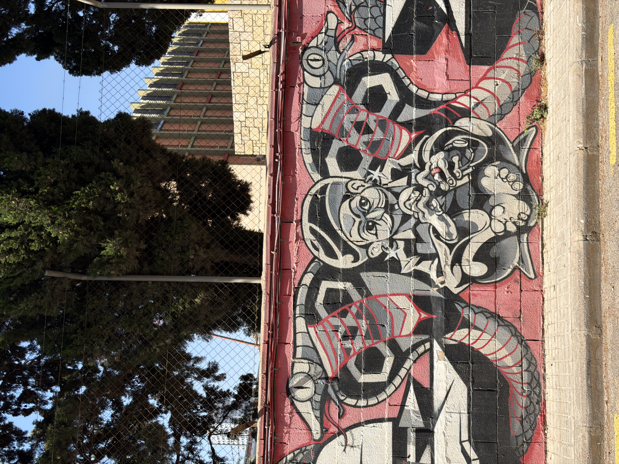 Street murals, scattered scooters, and soccer gear in an urban neighborhood