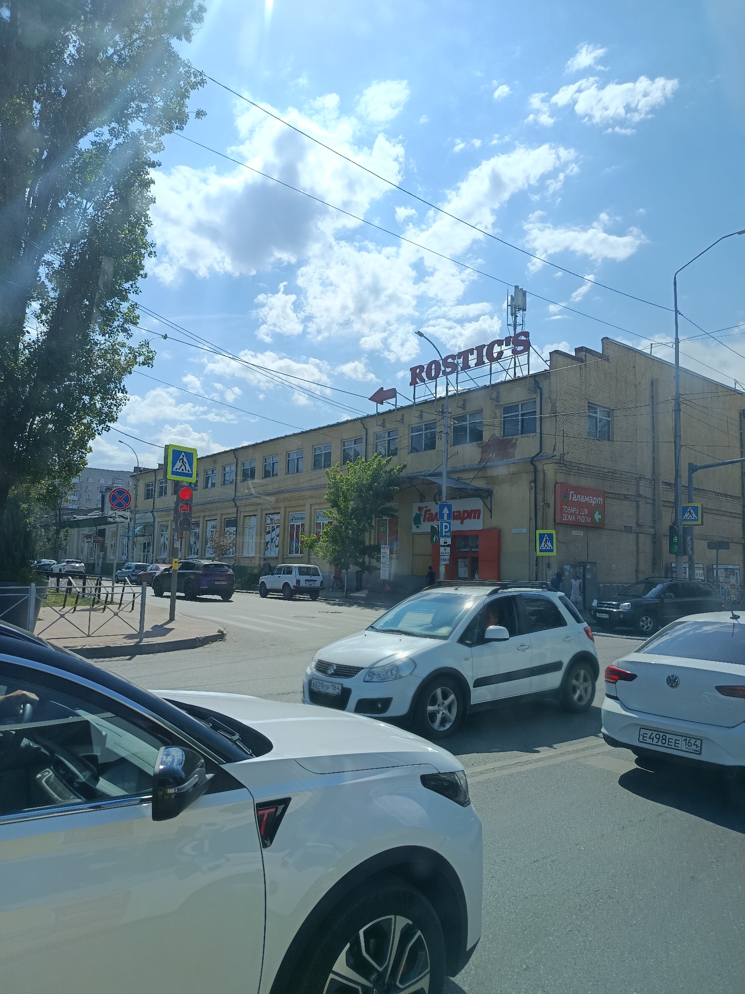 Colorful murals mark a sunny Saratov streetscape
