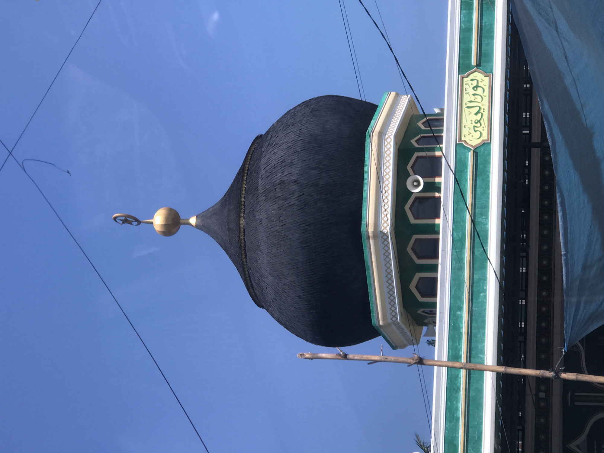 Mosque with distinctive dome and striped minaret observed in Lhokseumawe