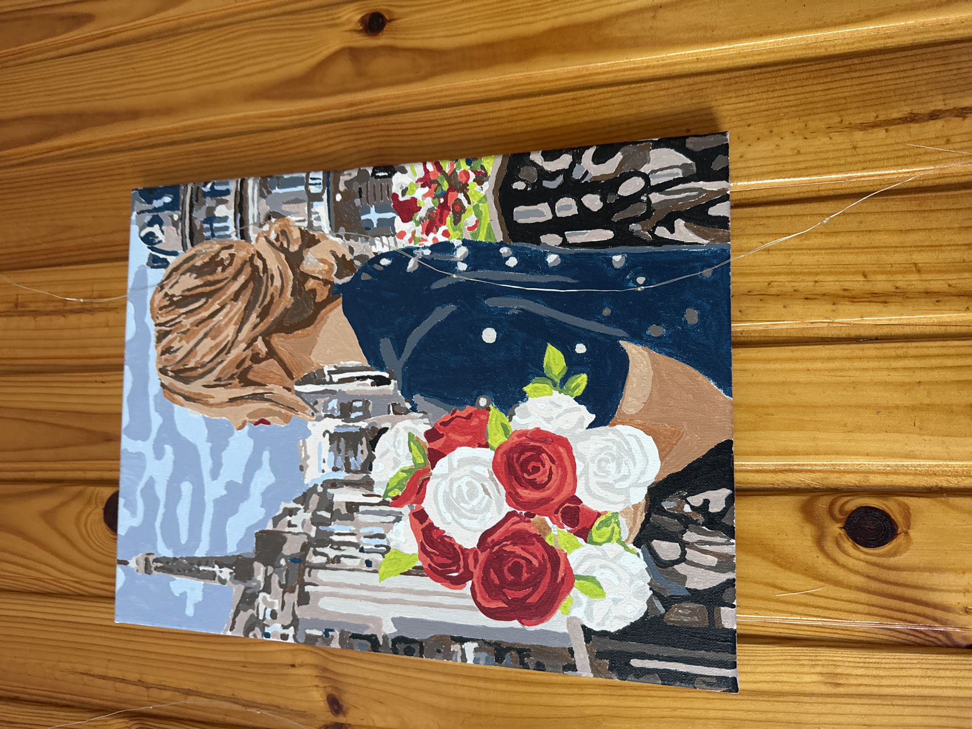 Three mounted artworks observed on wooden panel walls