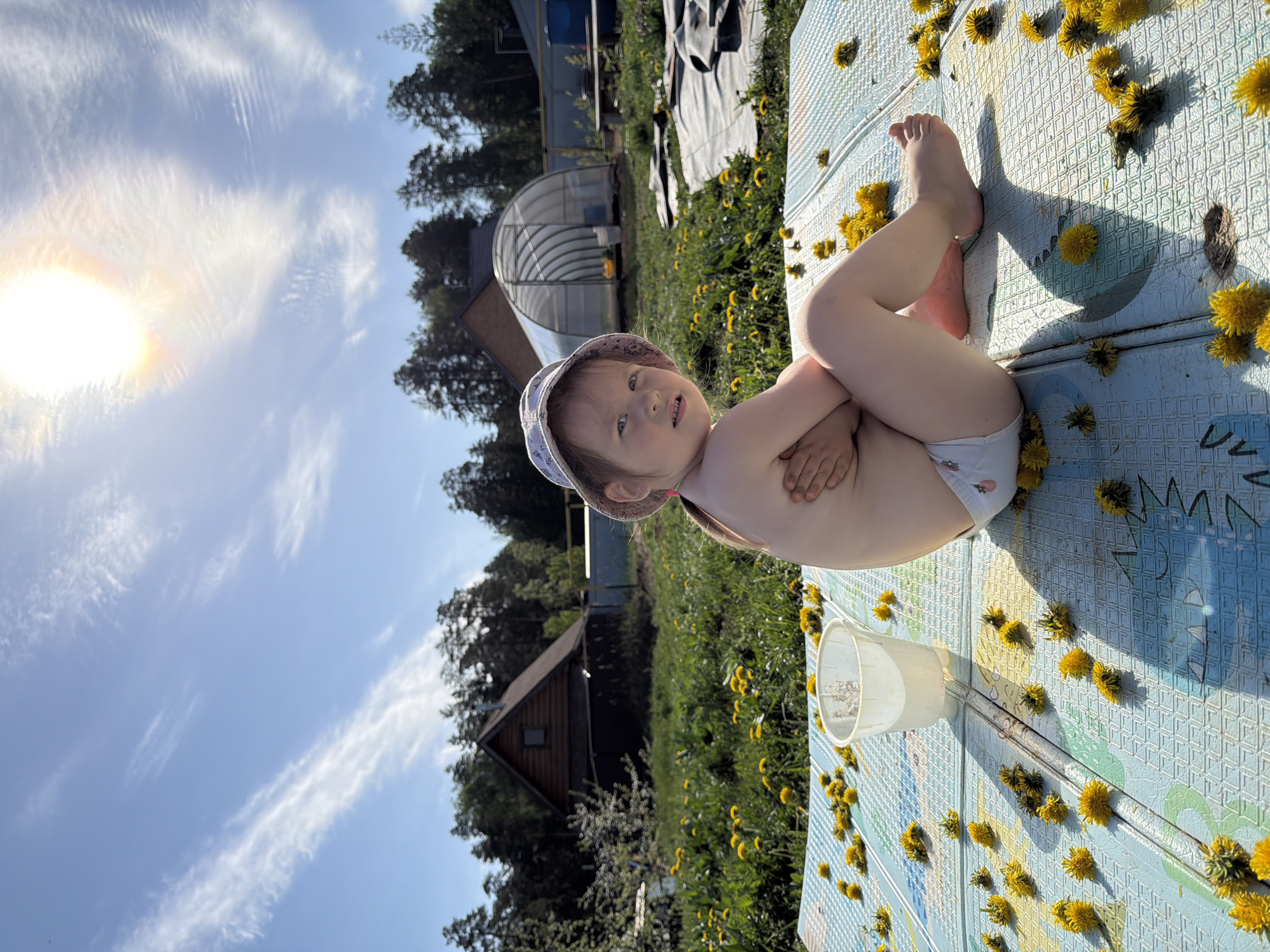 Family creates dandelion art on play mat in Chaikovsky