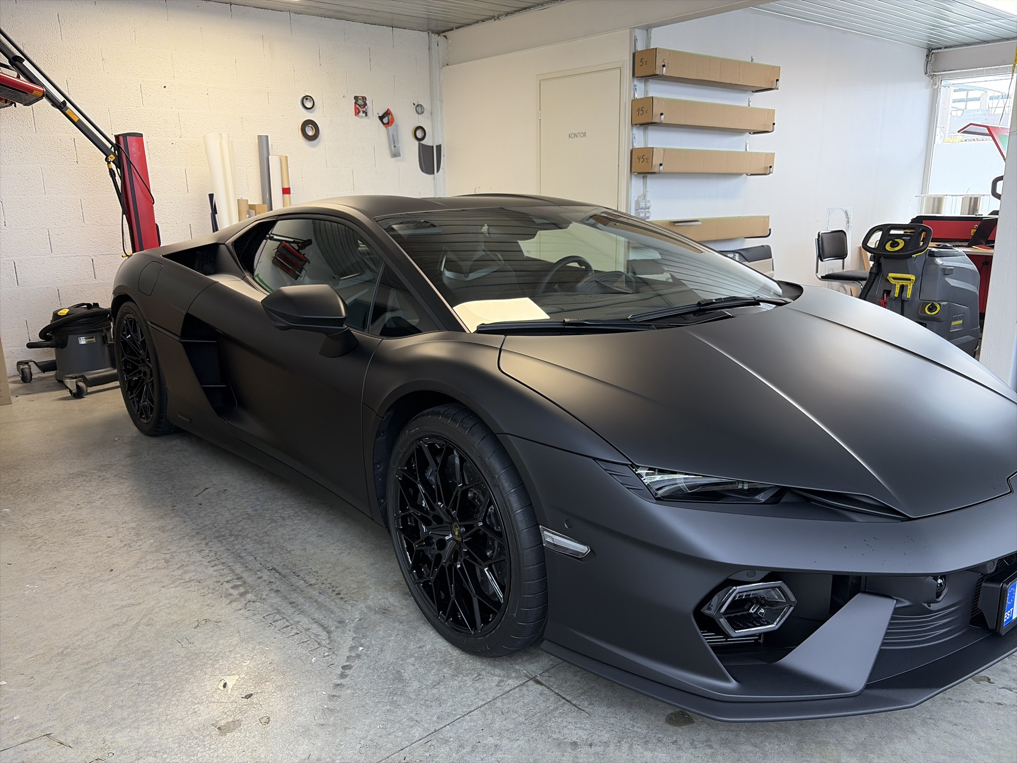 Matte black Lamborghini parked in a Estonian garage