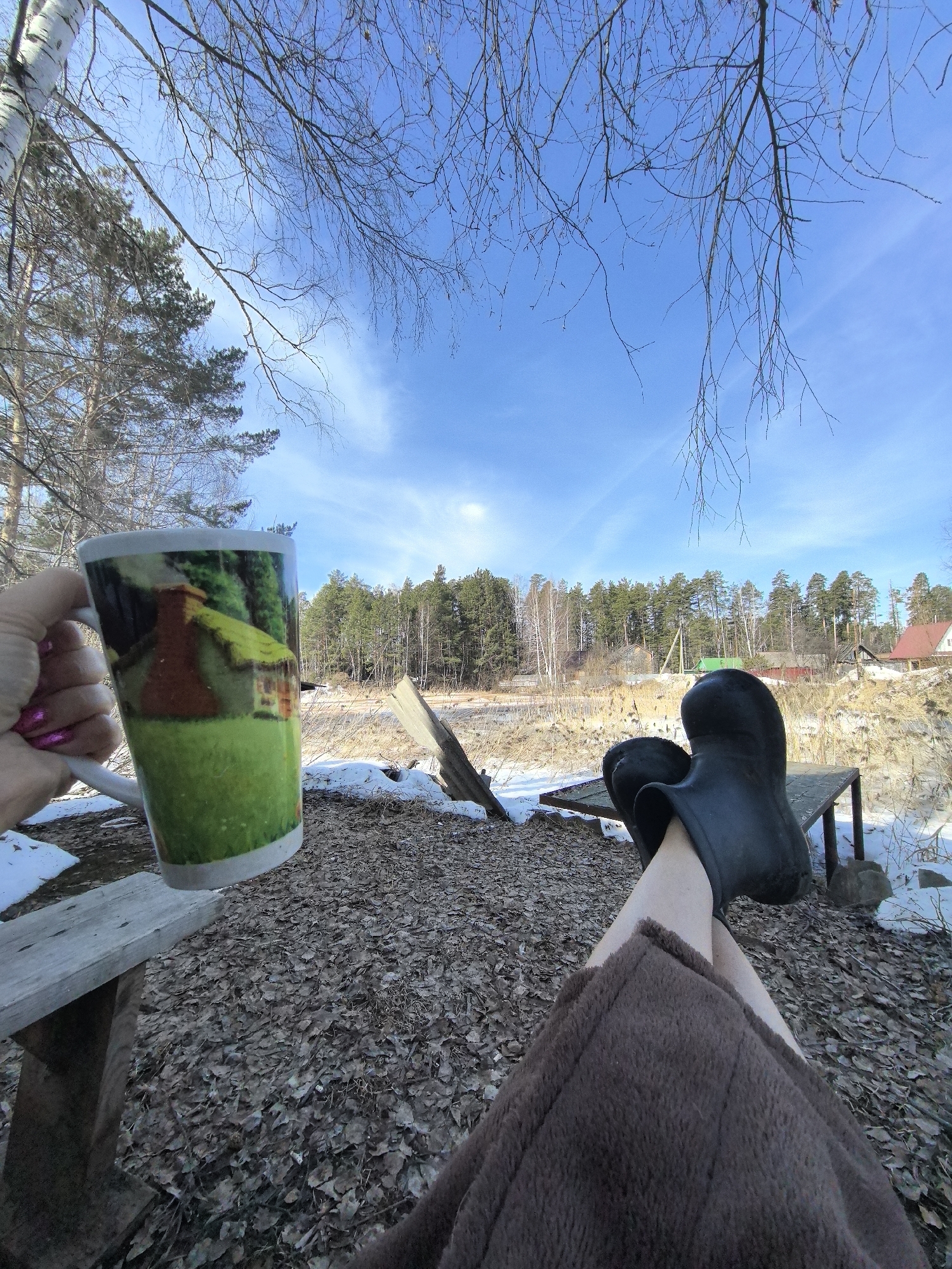 Person relaxing in snowy Russian countryside on sunny morning