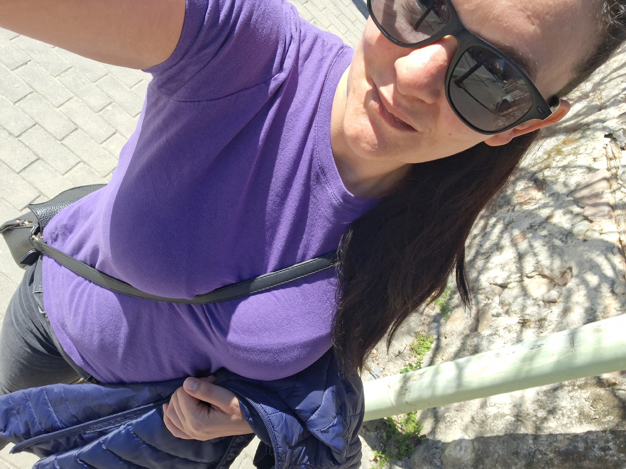 Woman poses outdoors in purple shirt in Goce Delcev