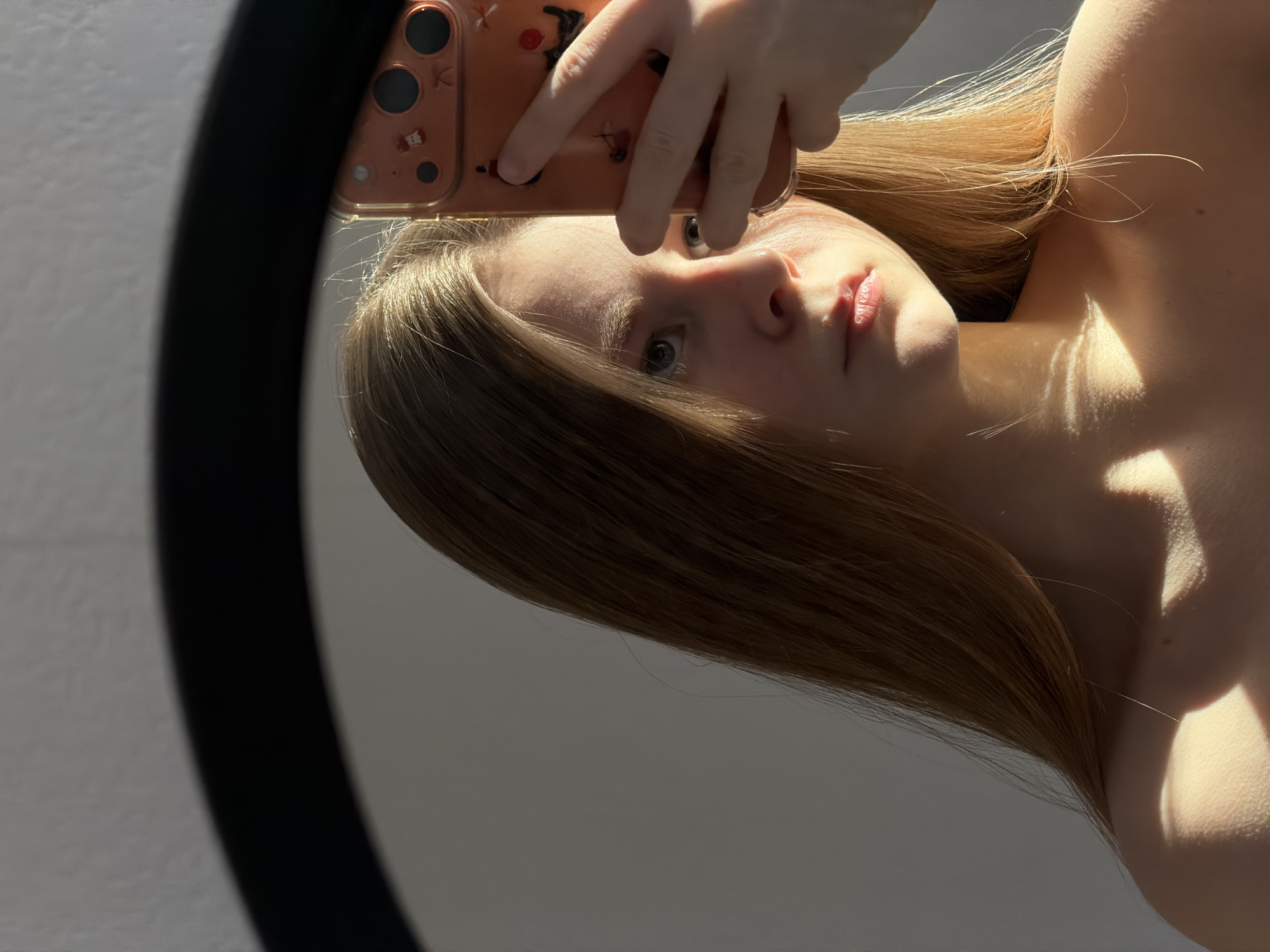 Woman documents hair-drying routine through selfies in Perm bedroom