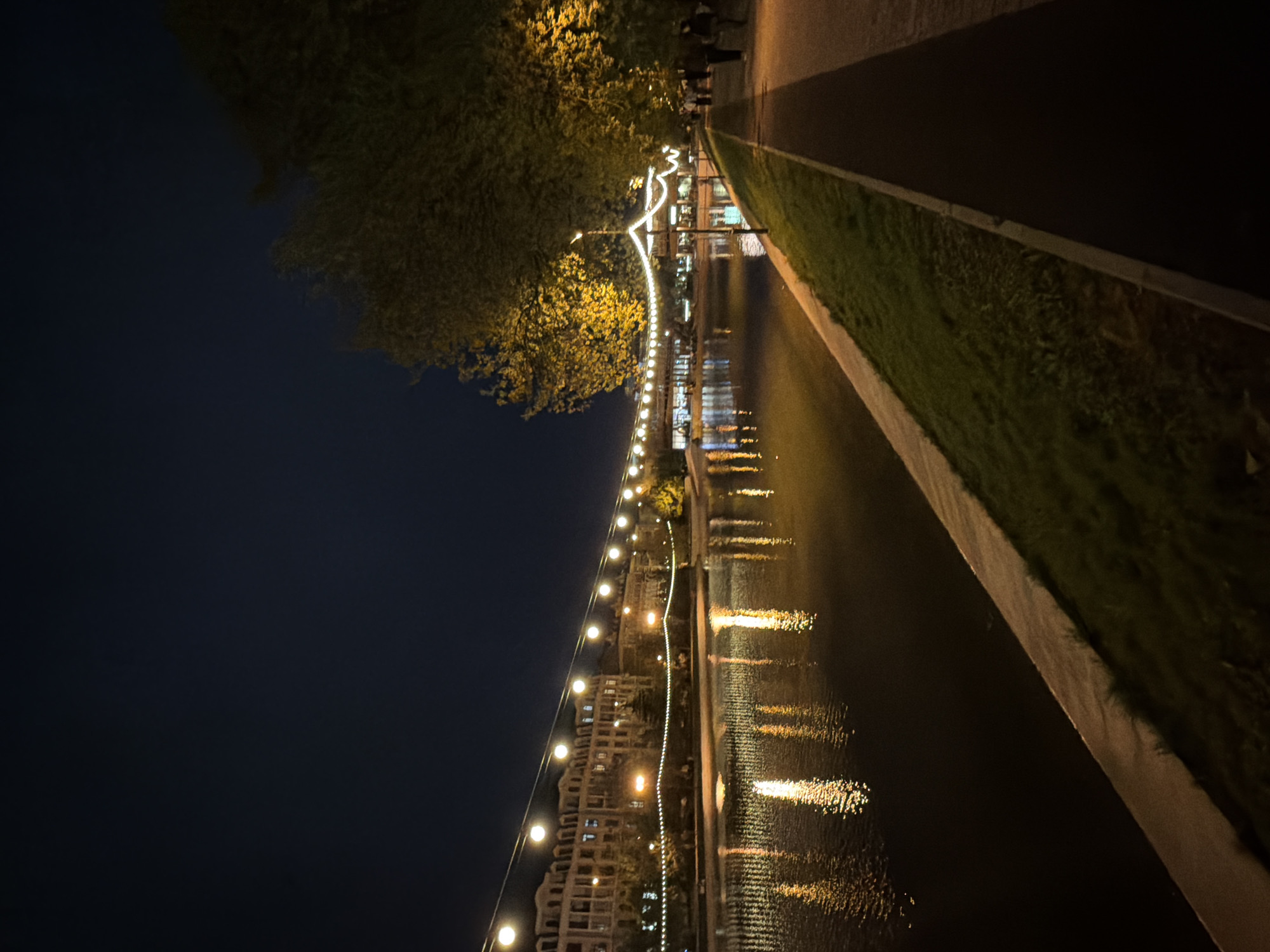 Evening stroll captured along illuminated Kazan canal walkway