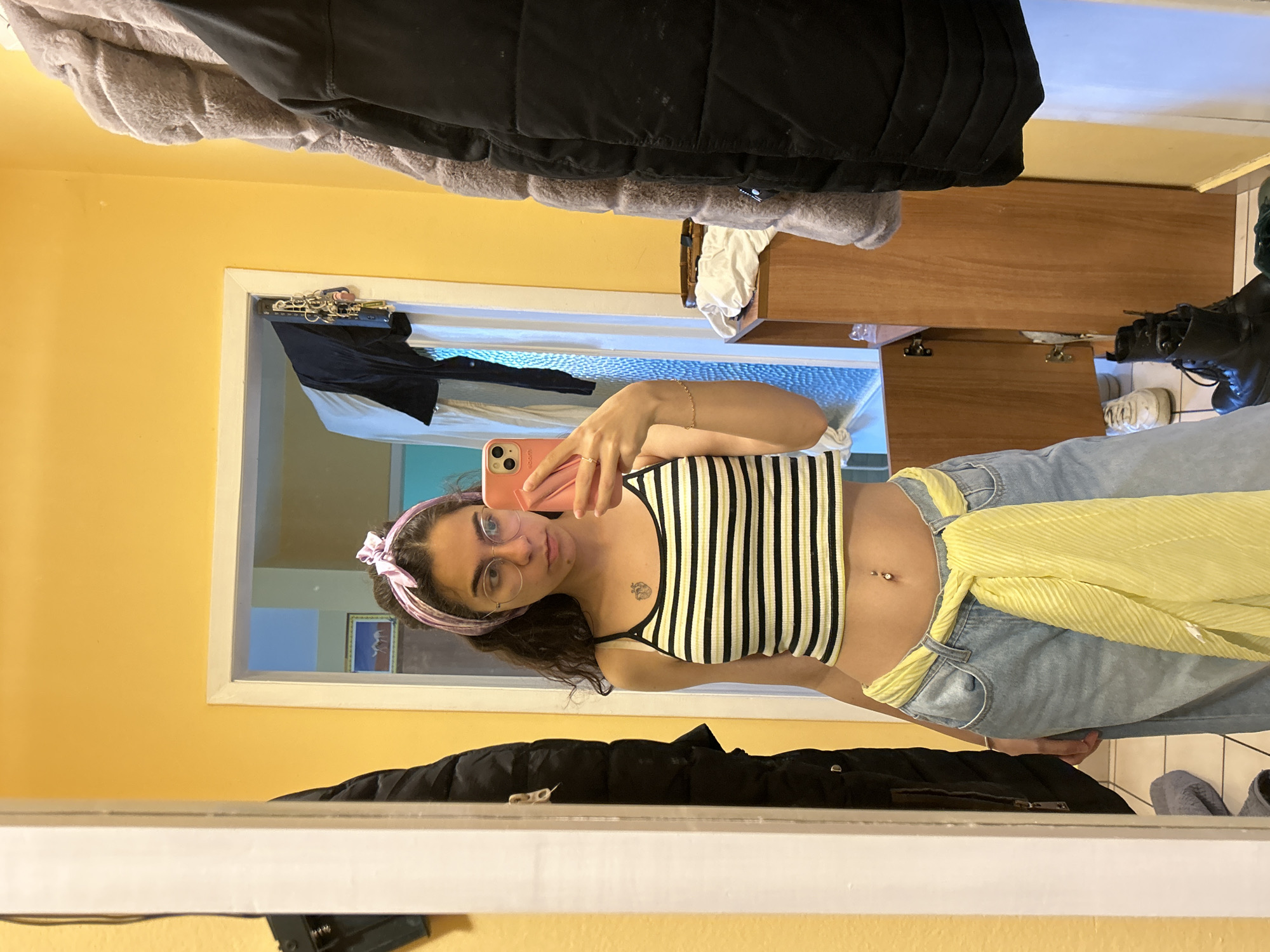 Woman takes mirror selfies in striped top in Sofia